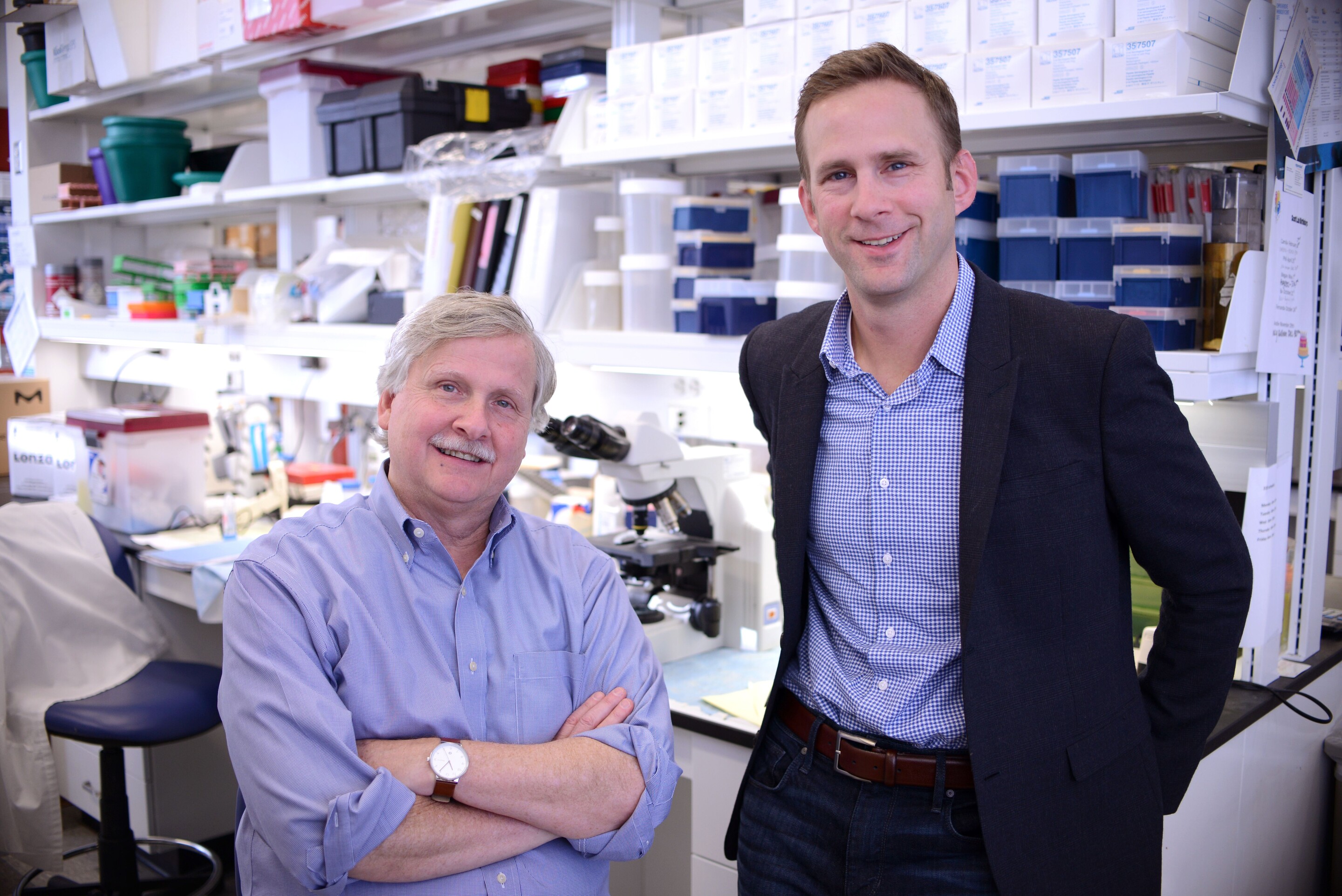 Scientists Phillip Scott and Daniel Beiting in a laboratory