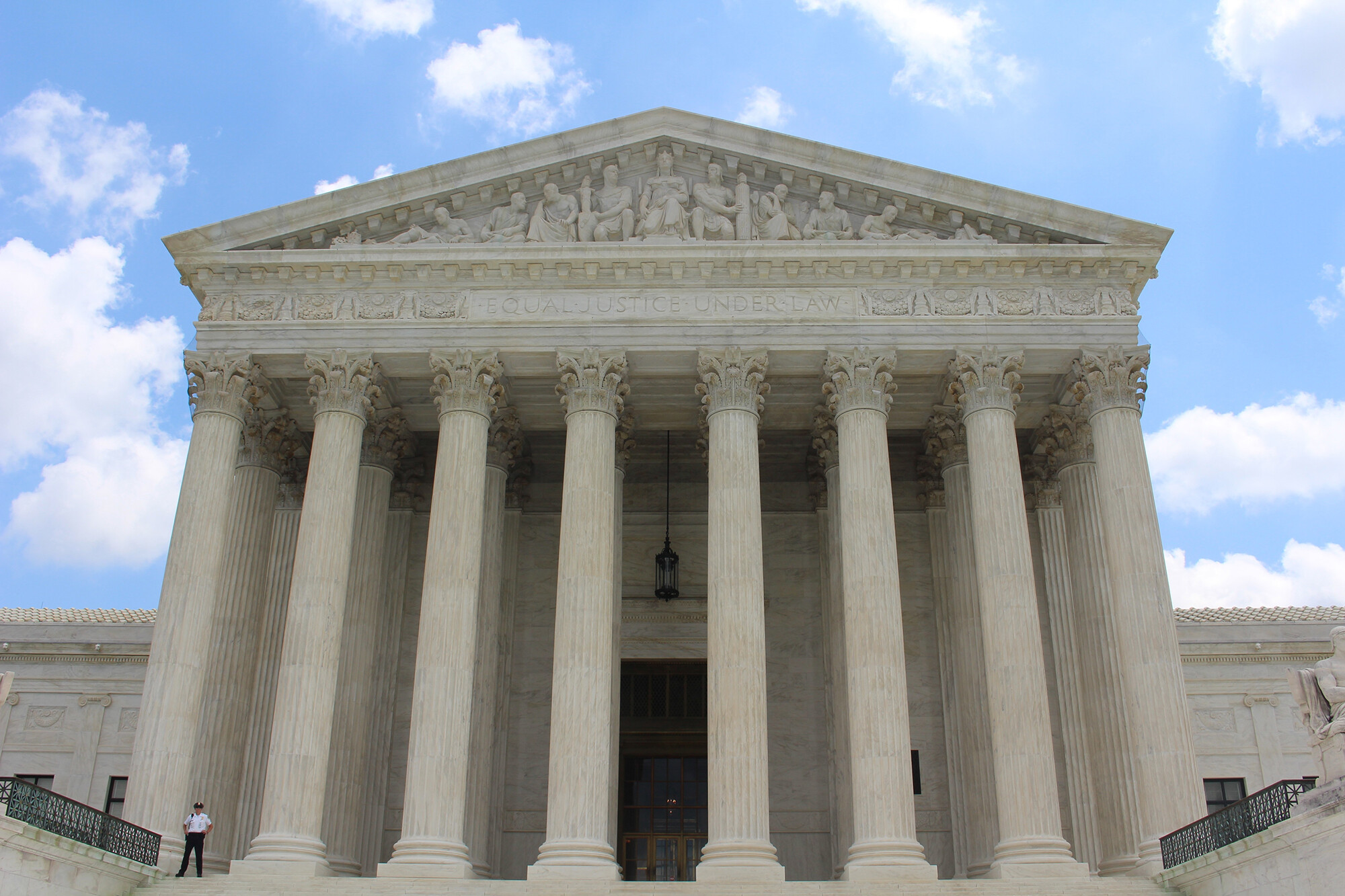Large columned federal building with words "Equal Justice Under Law" inscribed on front