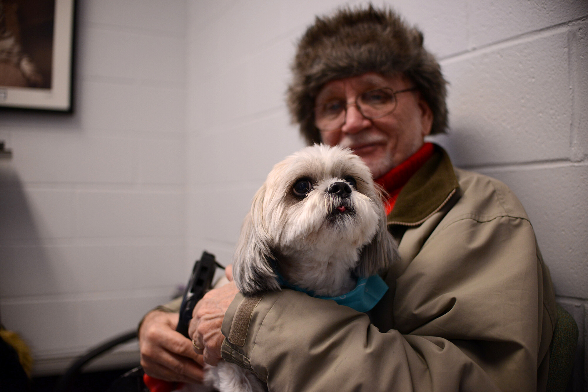 A dog sits on its owners lap in the waiting room at Ryan Hospital.