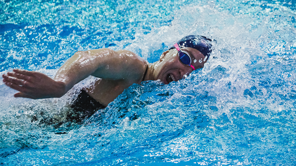 Catherine Buroker swims in a pool during a meet.