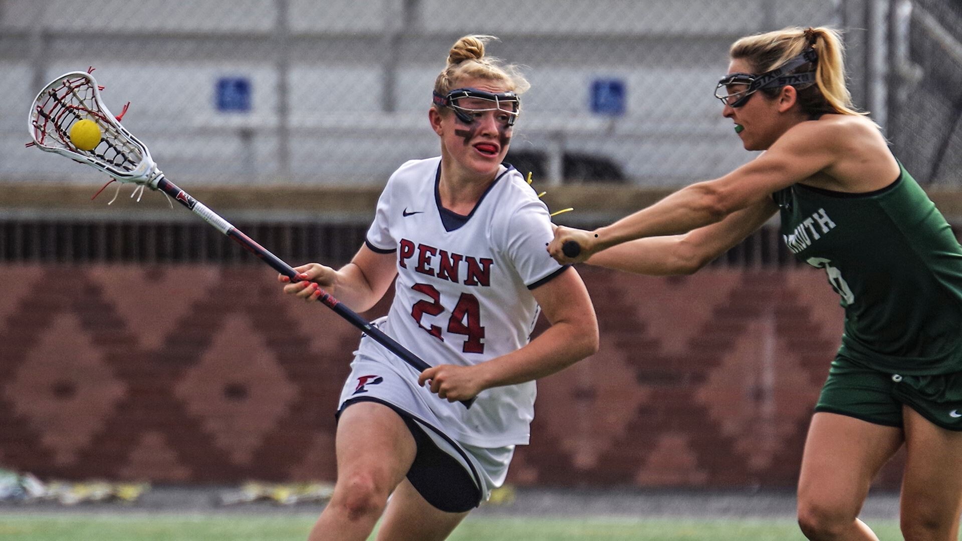 opposing player tries to block Rosenzweig as she runs past them with the ball