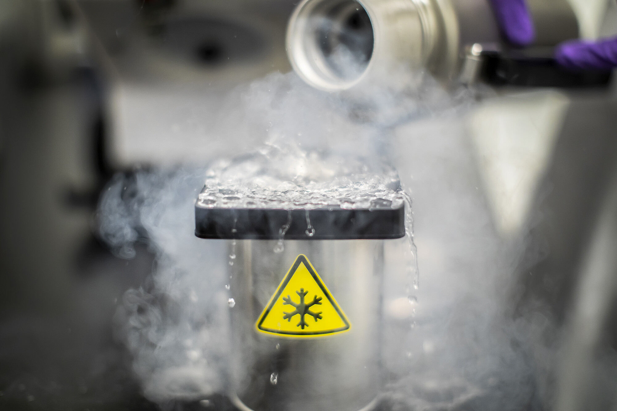 Closeup of frozen material poured into a vessel.