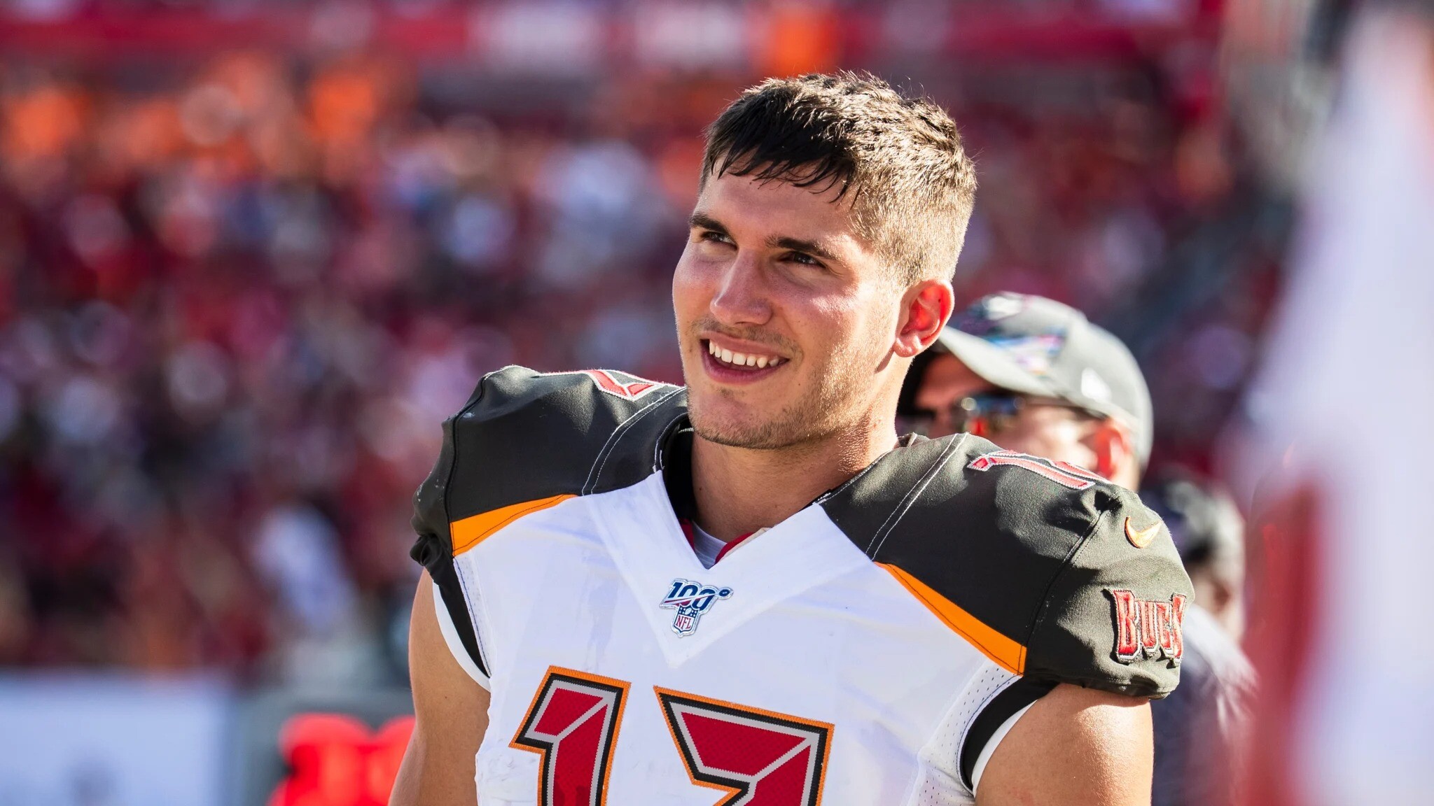Justin Watson stands on the sideline in his Tampa Bay jersey with his helmet off.
