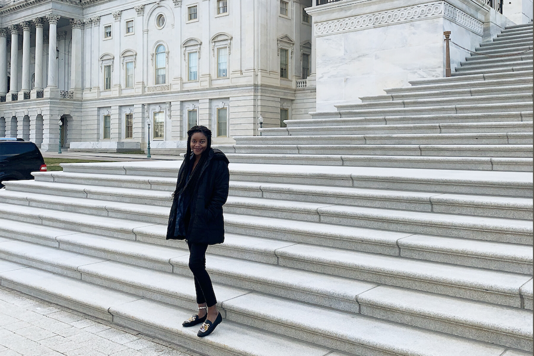 Student standing on marble steps