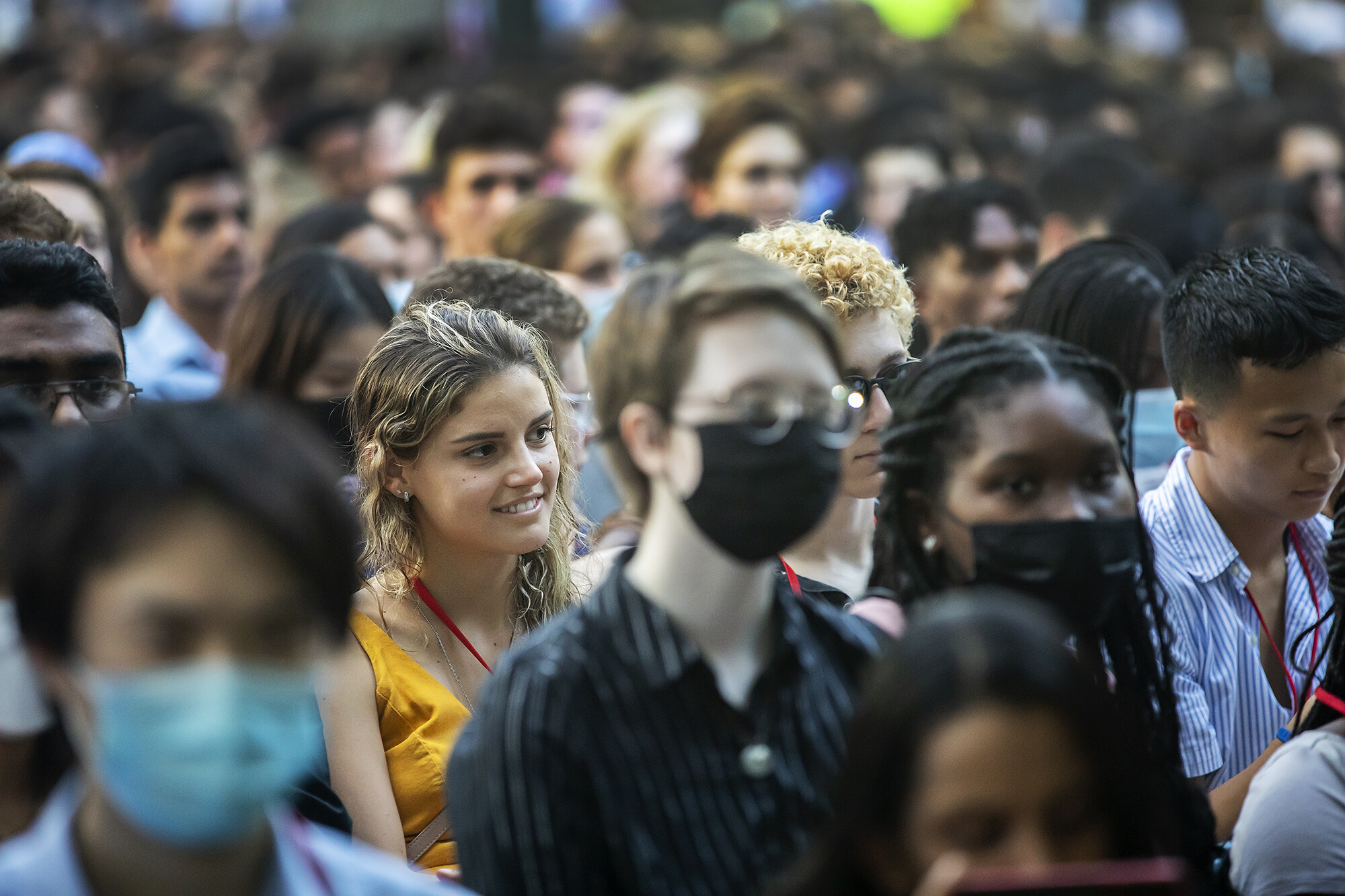 Giulia Fruet, and several students listen while seated during Convocation on College Green.