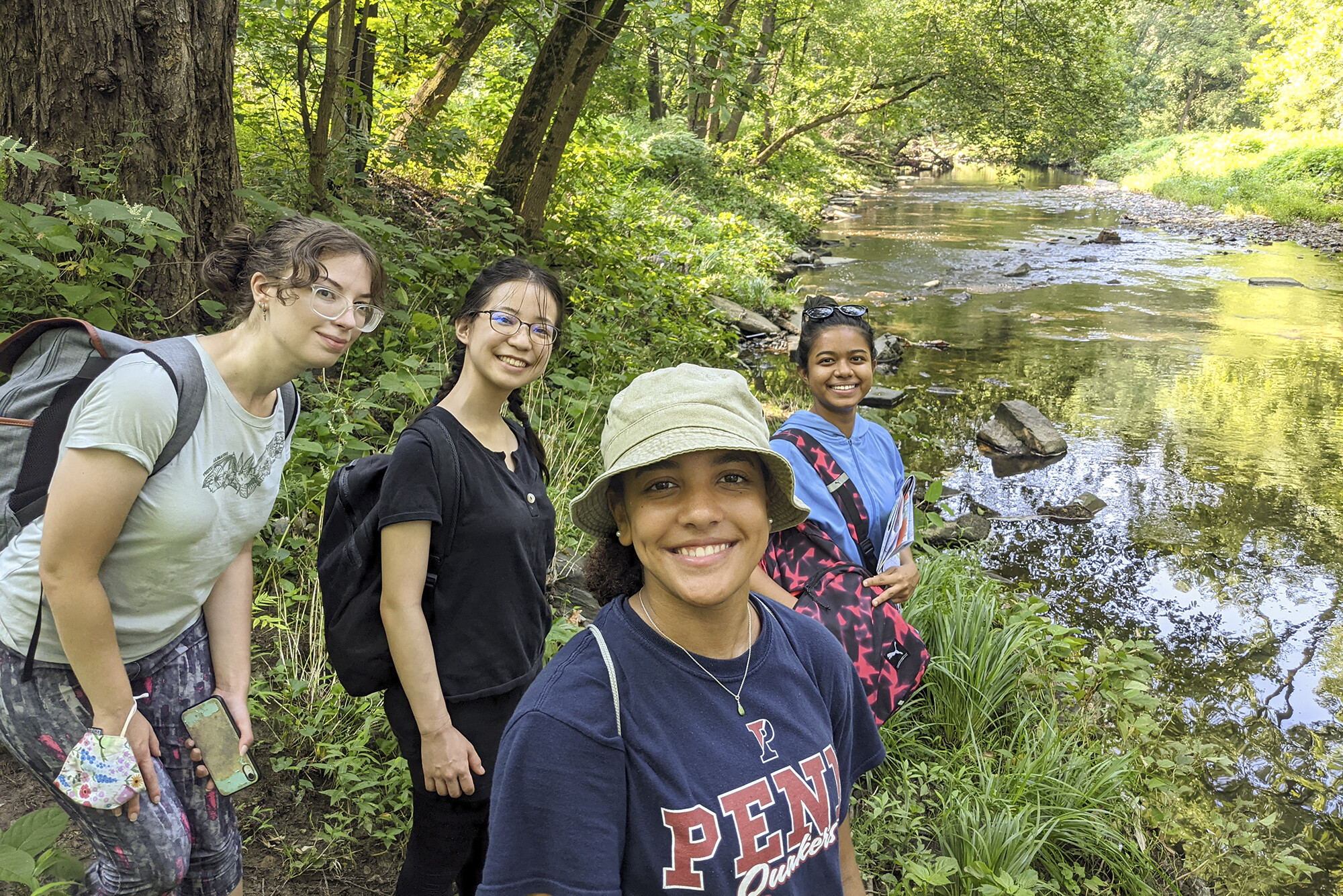Anna Balfanz, Ayana Shirai, Mya Gordon and Yasmin Abdul Razak along the banks of Cobbs Creek
