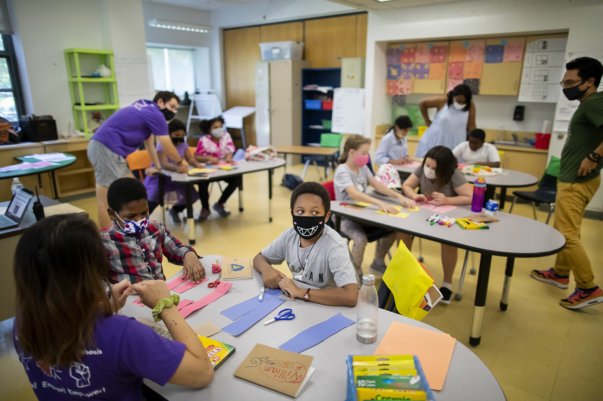 students in classroom during projects for progress