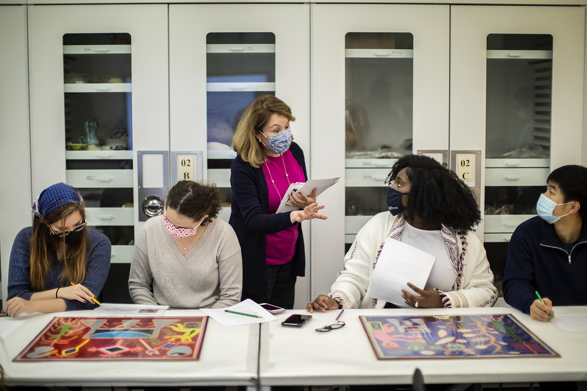 professor with four students and two artworks 