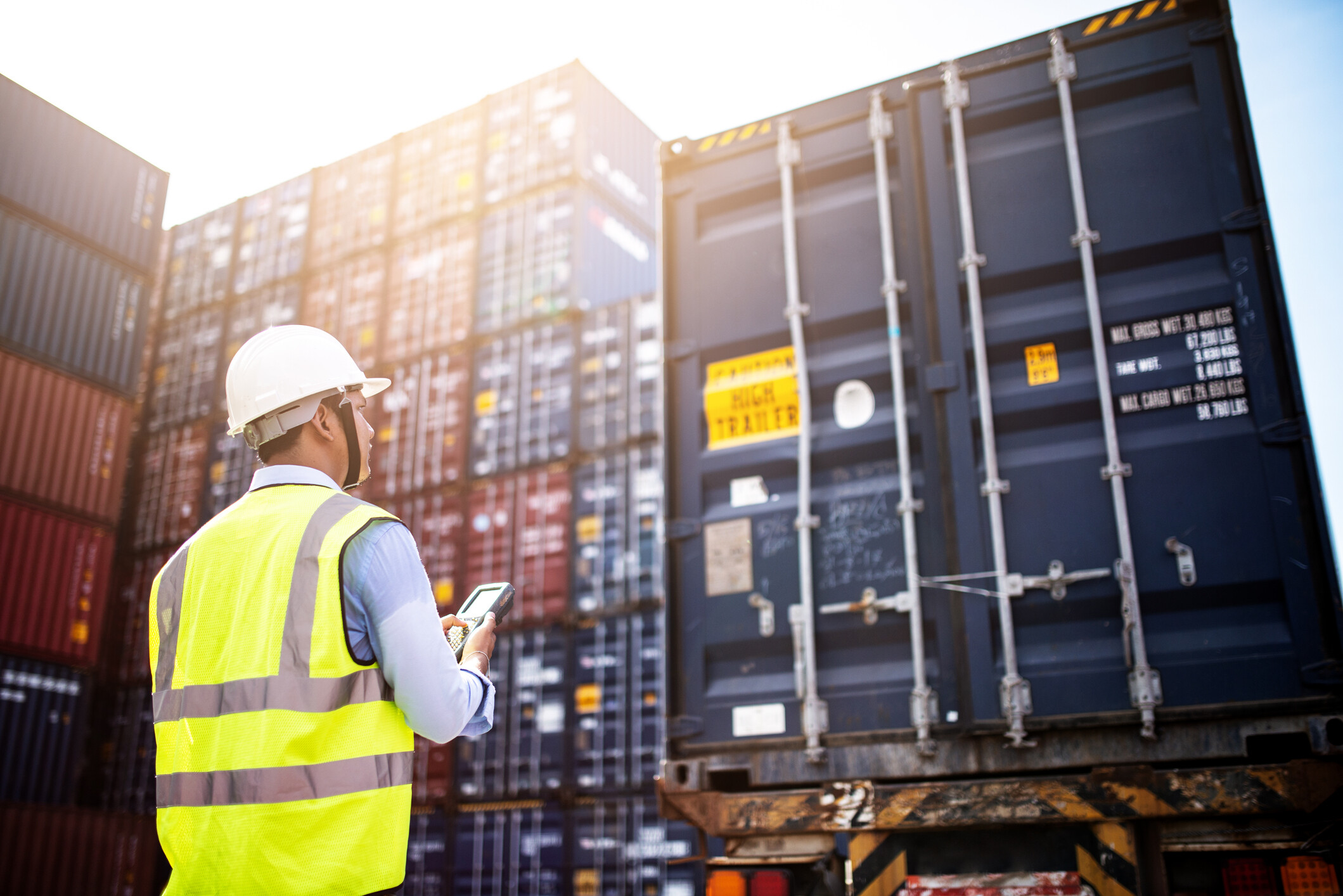 worker looking at trucking container