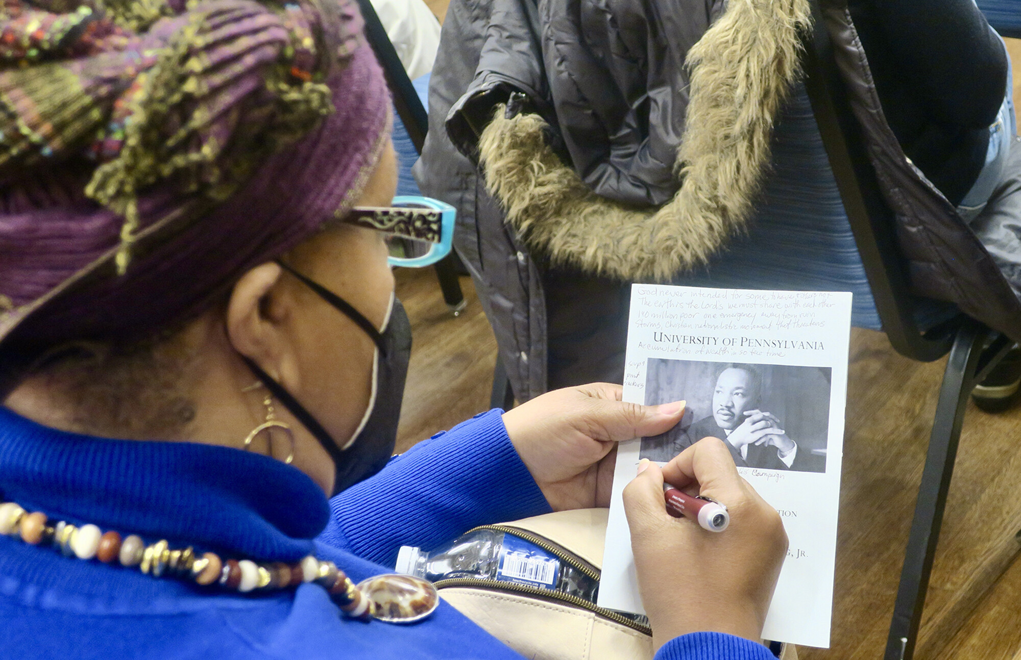 An audience member writes on their program.
