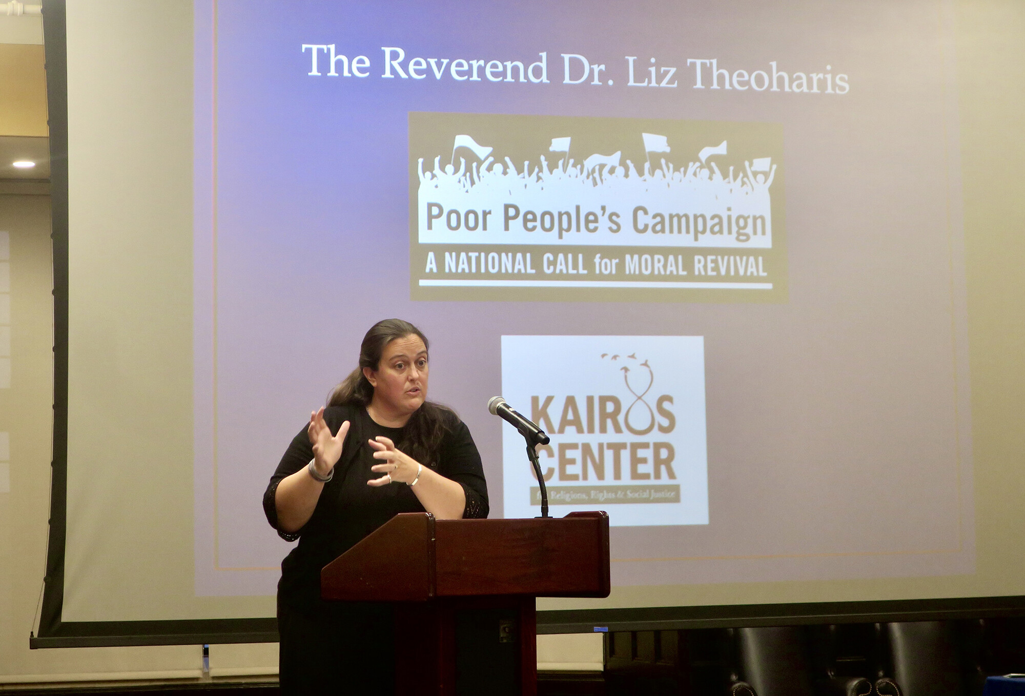Liz Theoharis speaks at a podium.