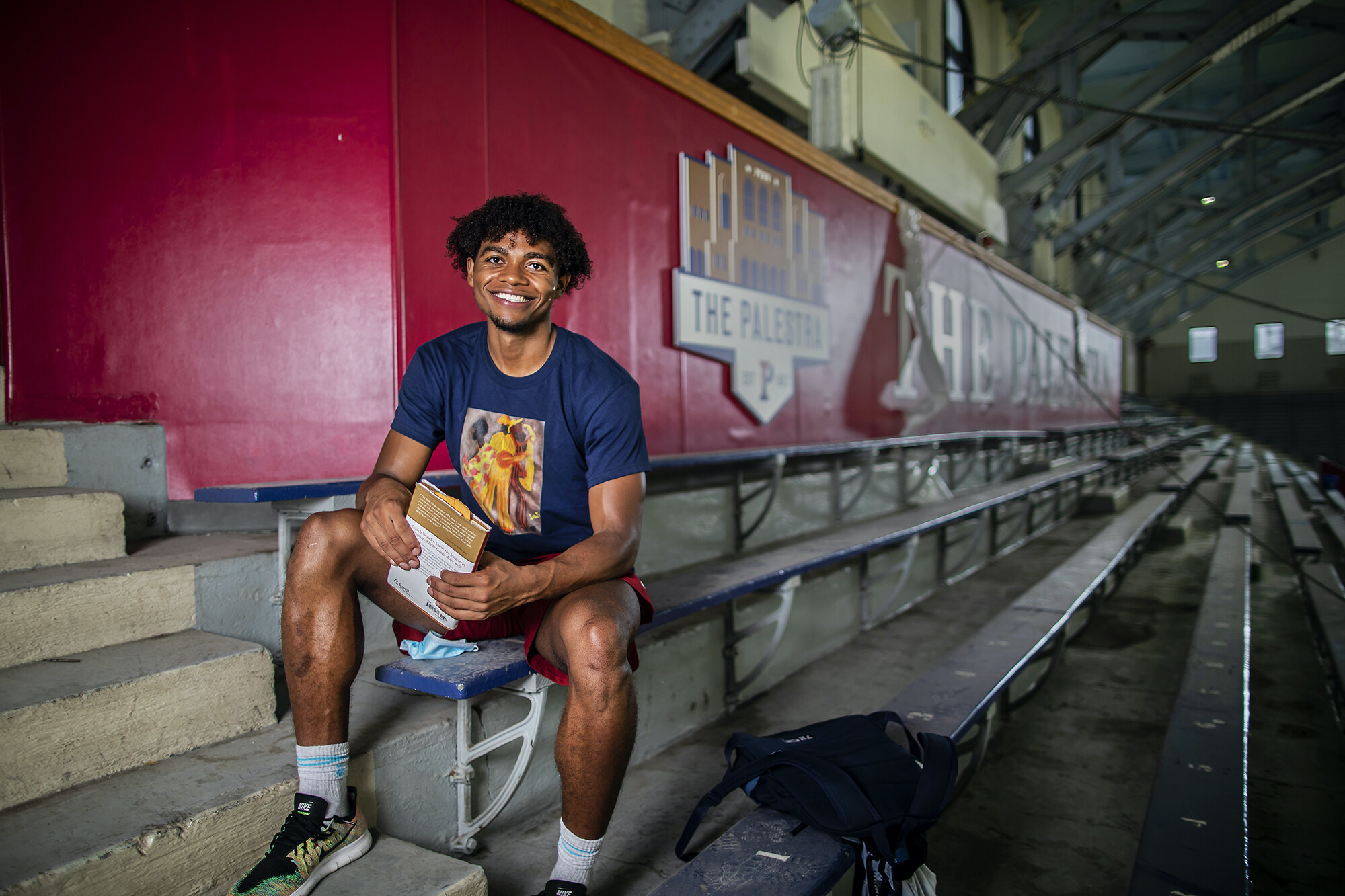 Lucas Monroe sits in the bleachers at the Palestra.