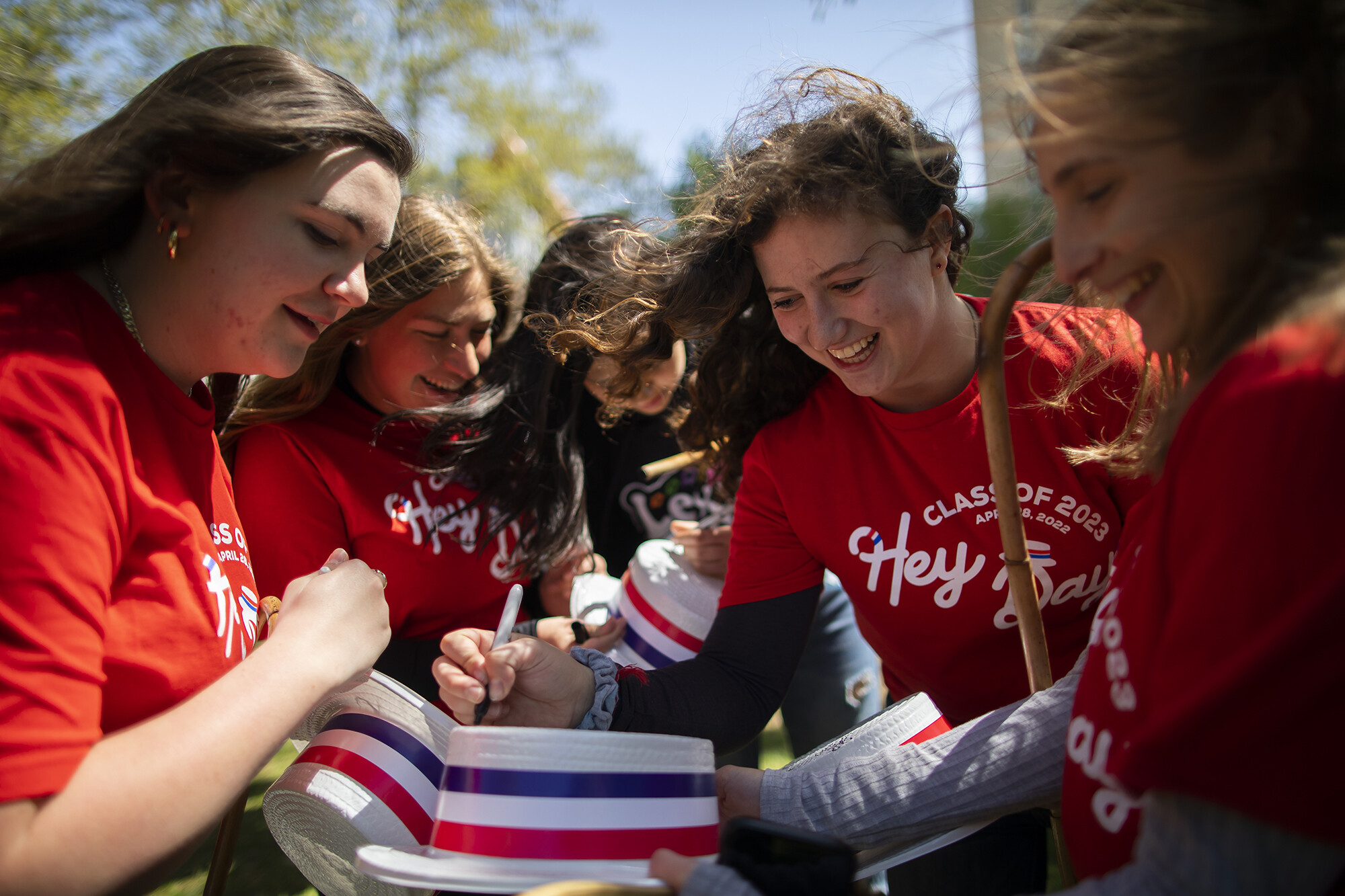 students signing hats at hey day