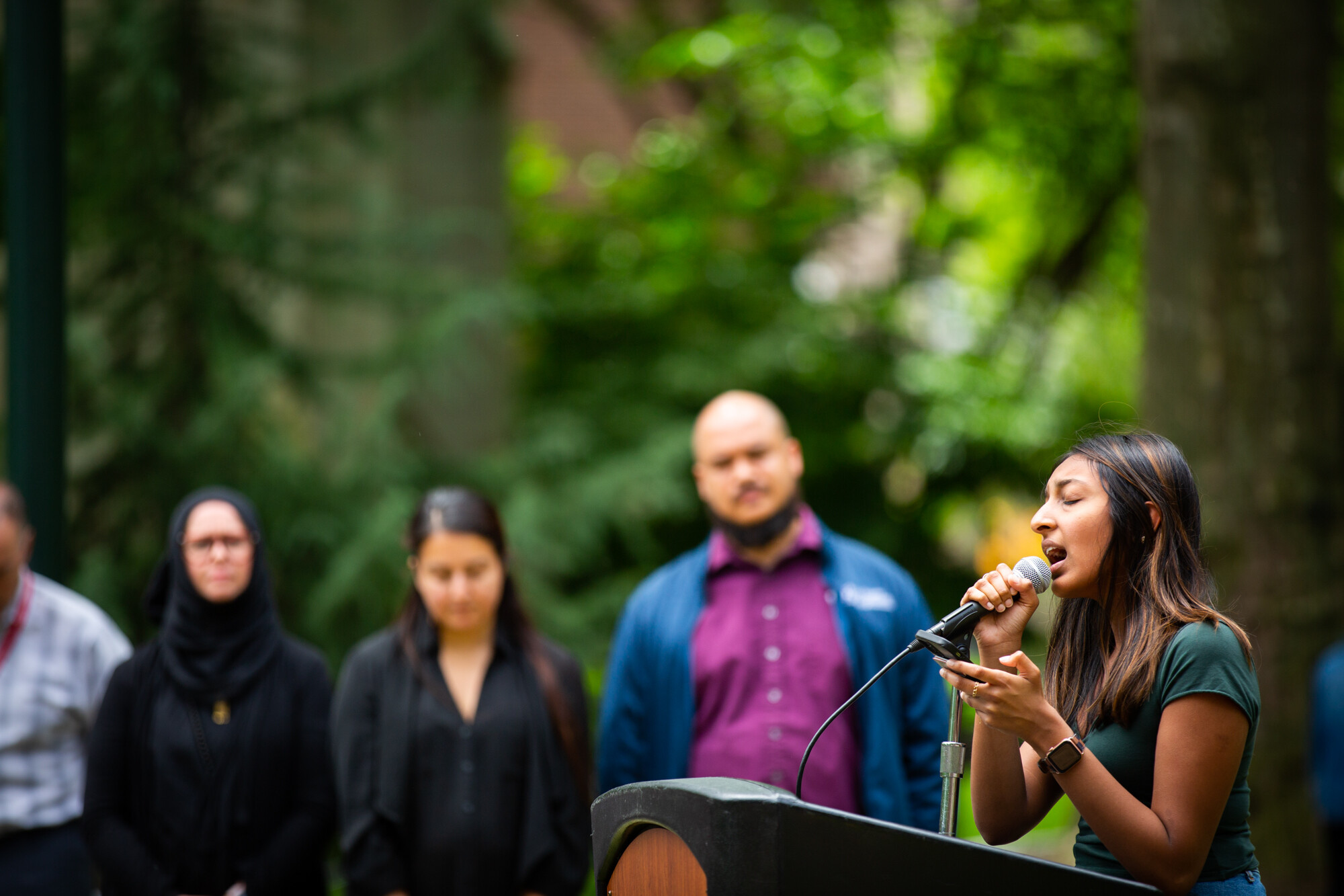 A person speaks at a podium at Penn’s gun violence vigil.