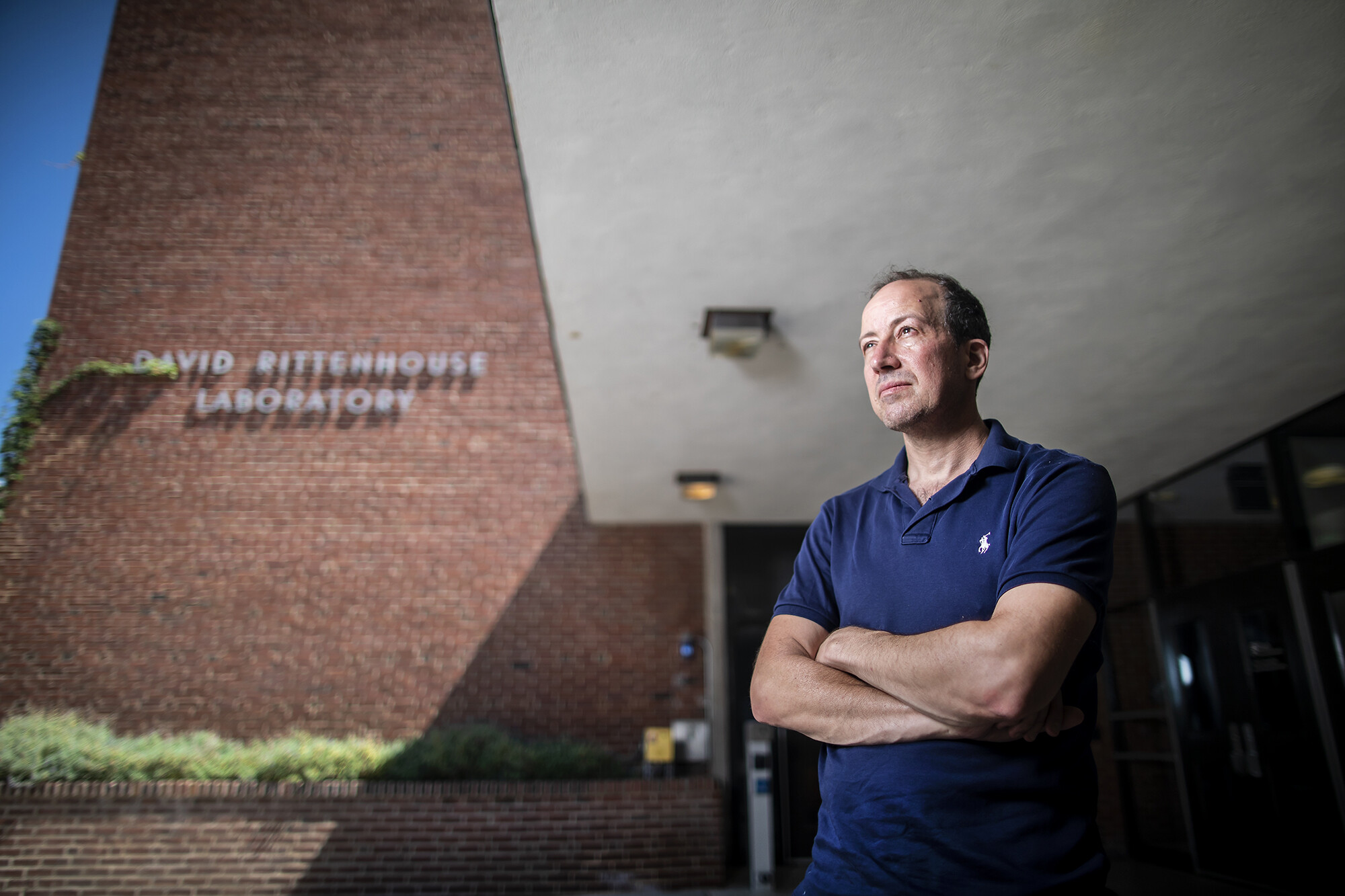 Elliot Lipeles gazes into the distance in front of David Rittenhouse Laboratory