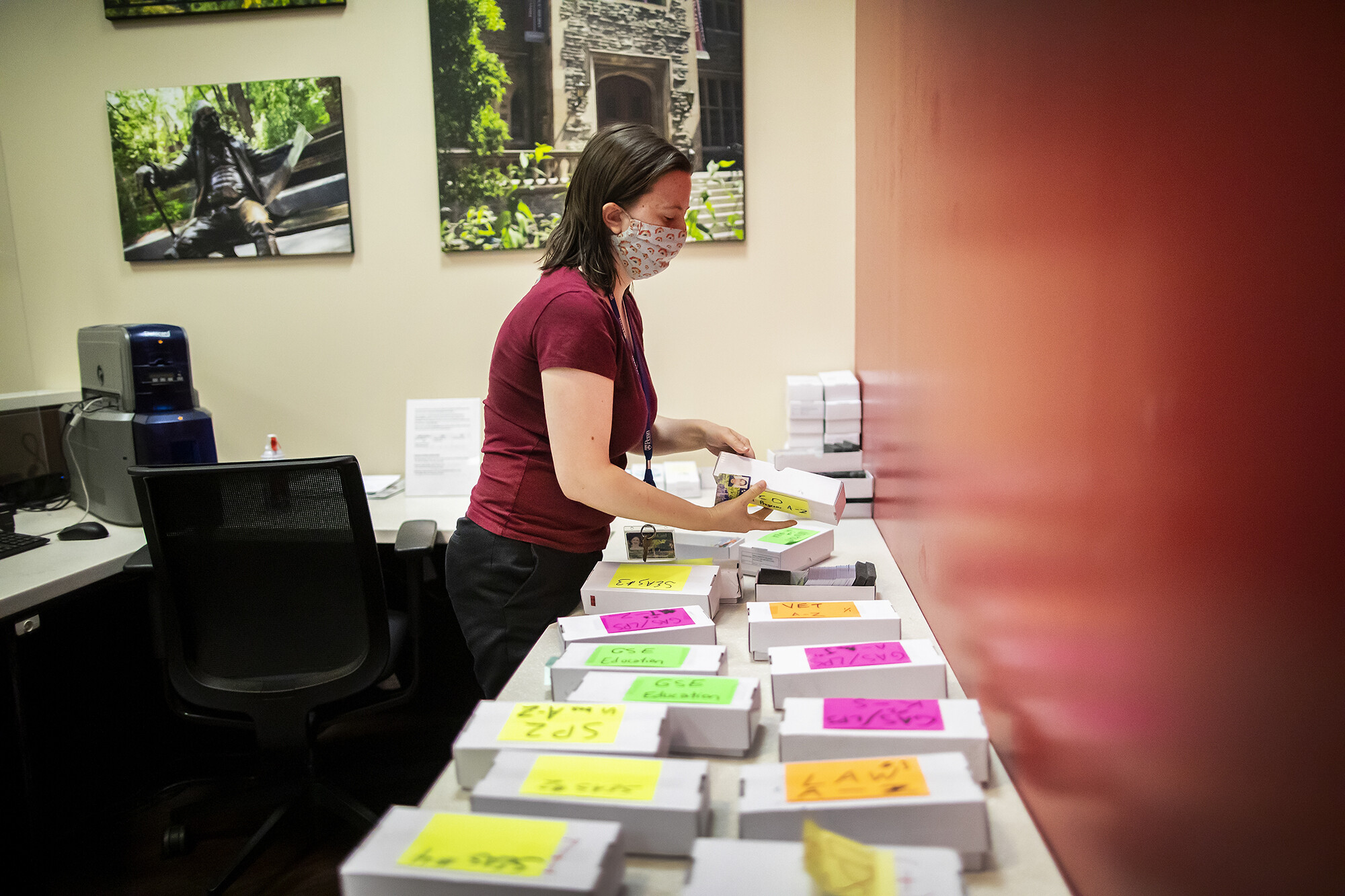 A worker at the PennCard Center organizes stacks.