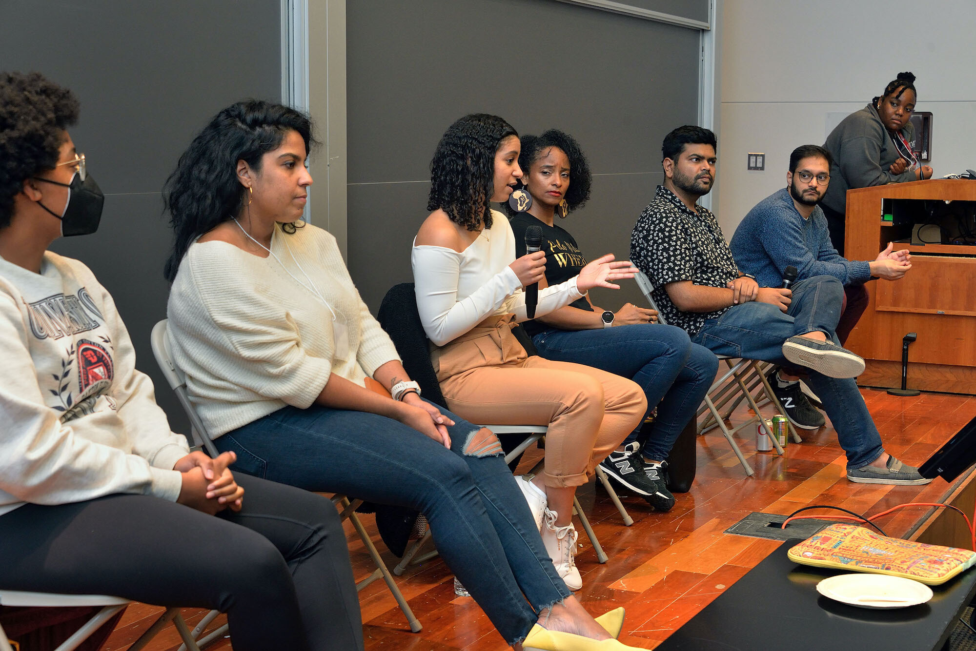 A panel of students and postdocs speak to a group