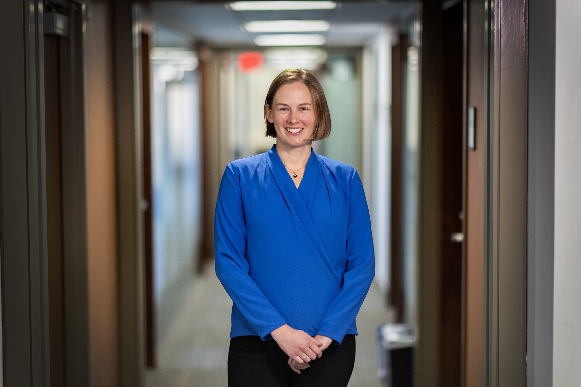Emily Largent smiles for a portrait outside of her office