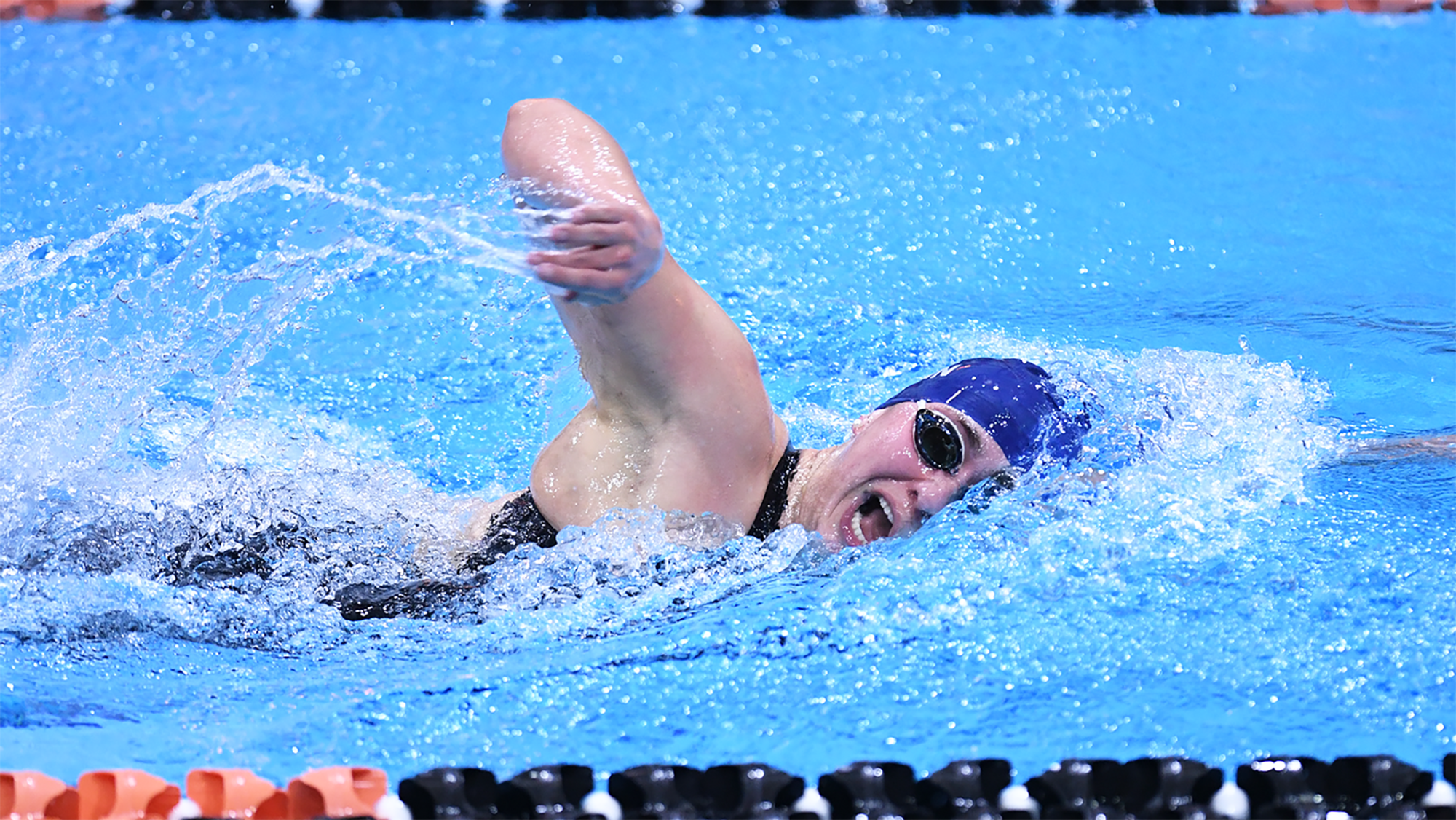 Anna Kalandadze takes a breath while swimming a lap at the Ivy League Championships.
