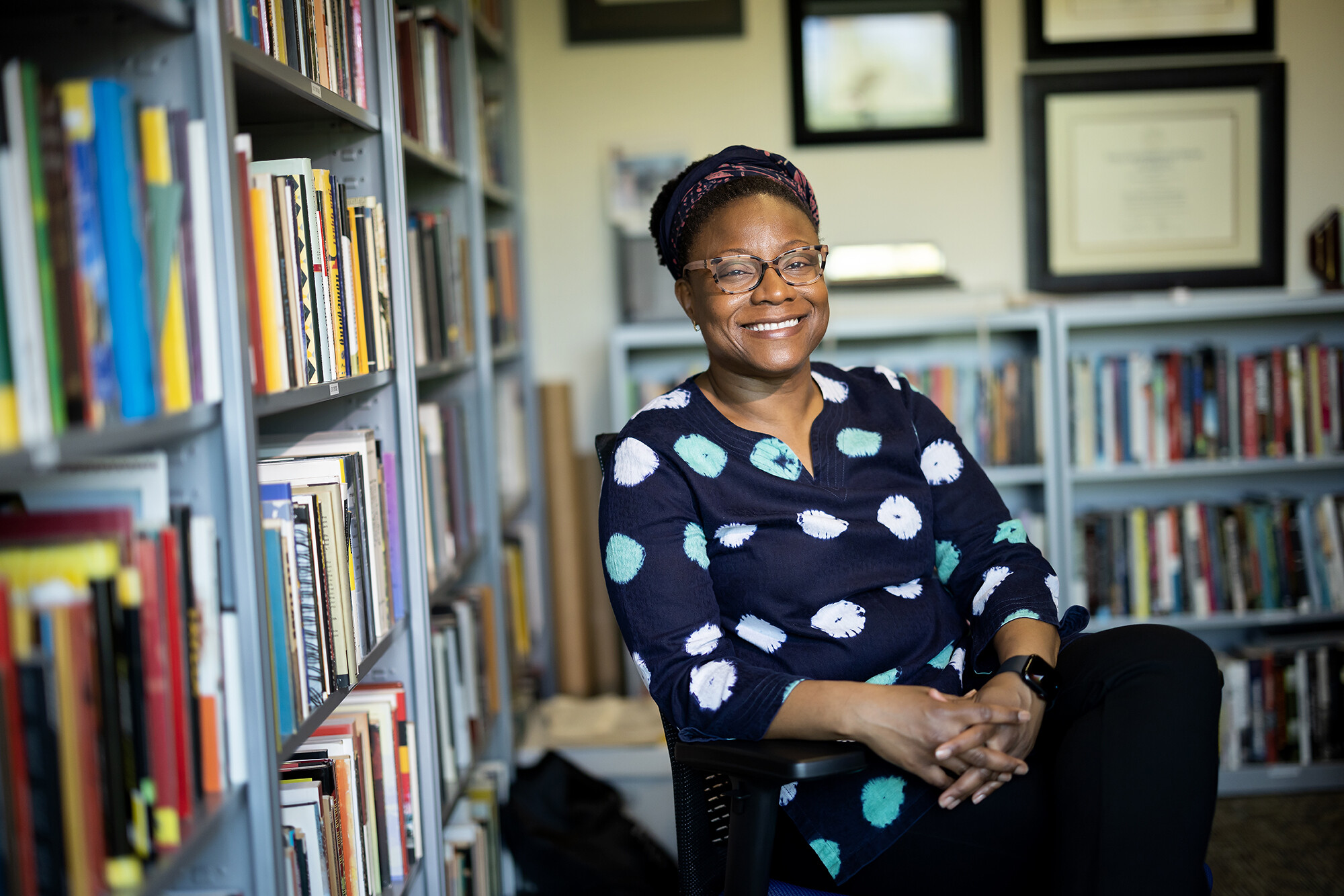 Keisha-Khan Perry in her office, surrounded by books