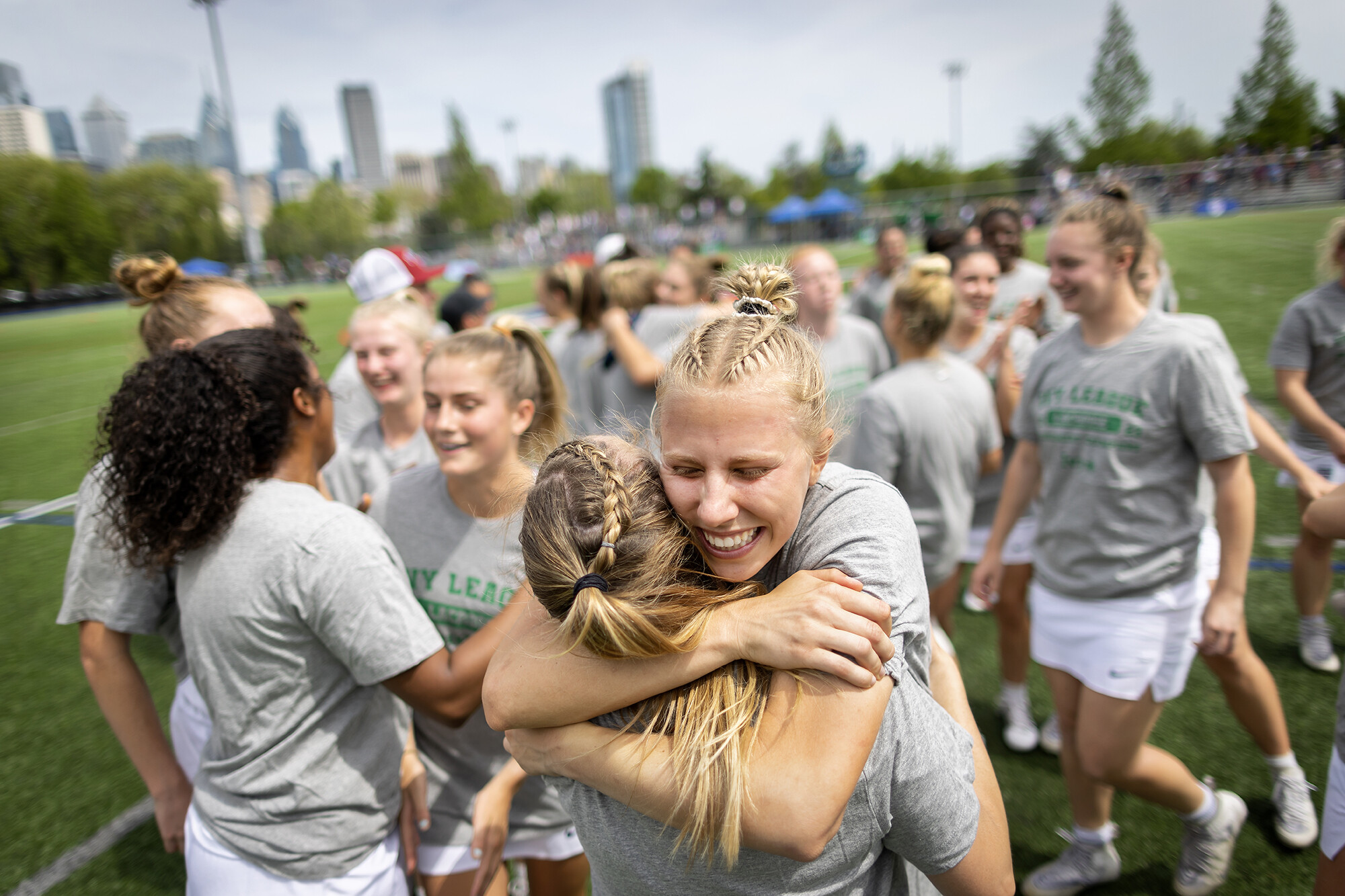 women's lacrosse players hug each other and celebrate