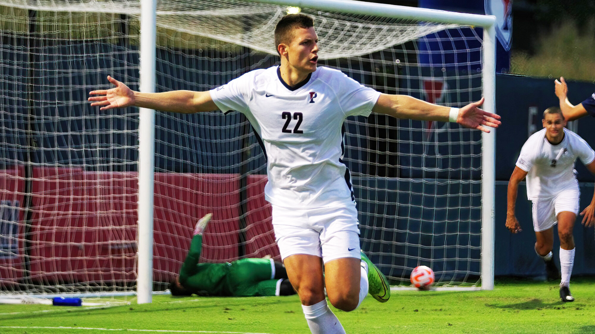 Stas Korzeniowski holds his arms out in celebration after scoring a goal during a game.