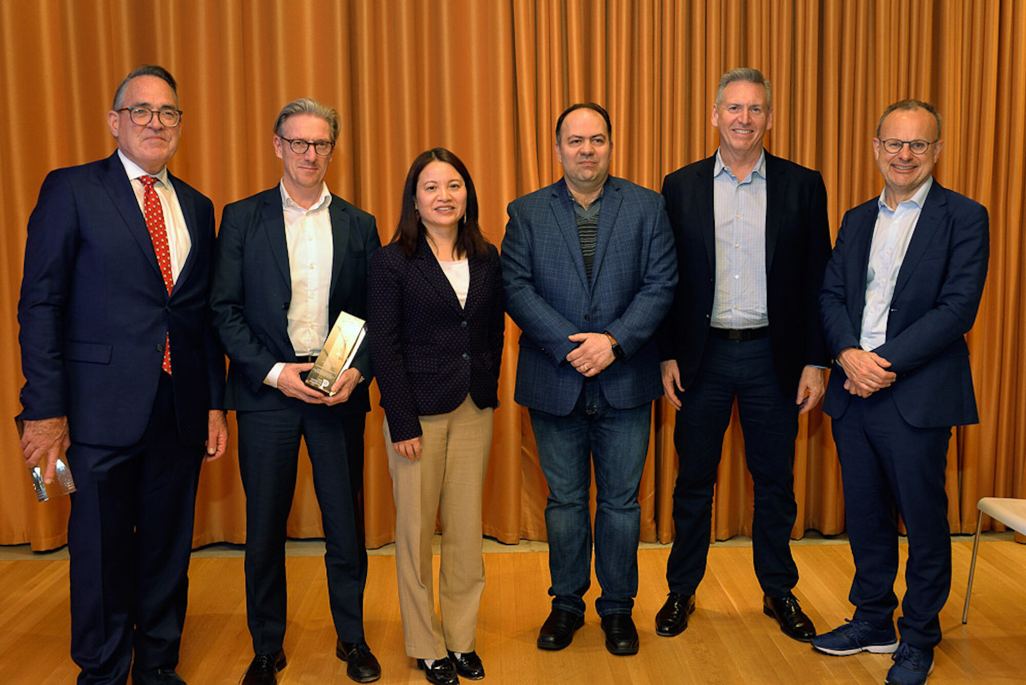 Sean McCooe, Holger Kissel, Shu Yang, Firooz Alfatouni, Steve Kelly, and Sean Marett pose for photograph at an award ceremony. 