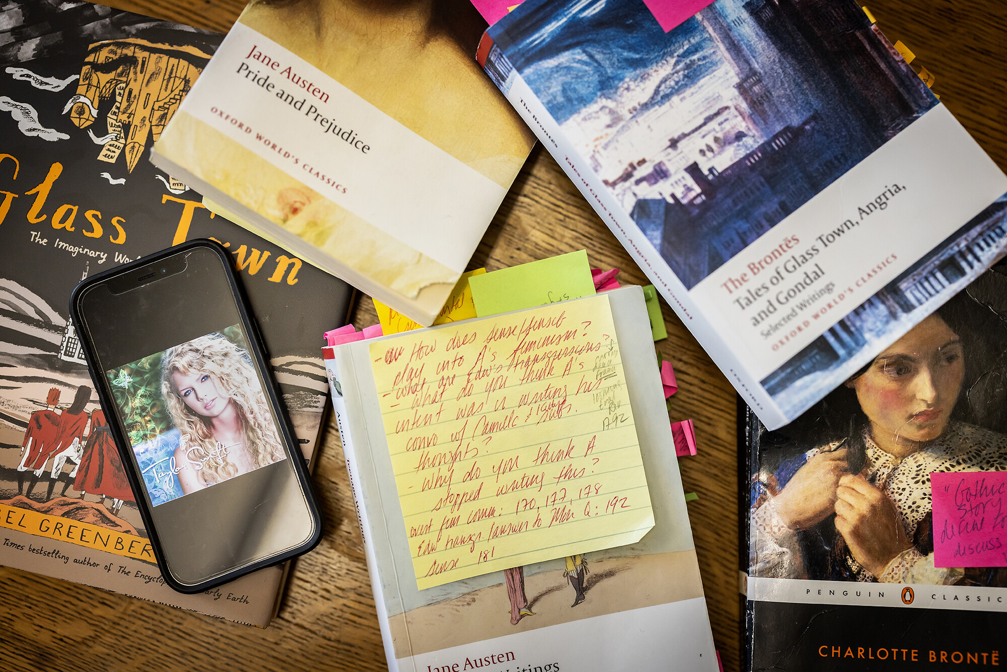 several books on a table with a phone