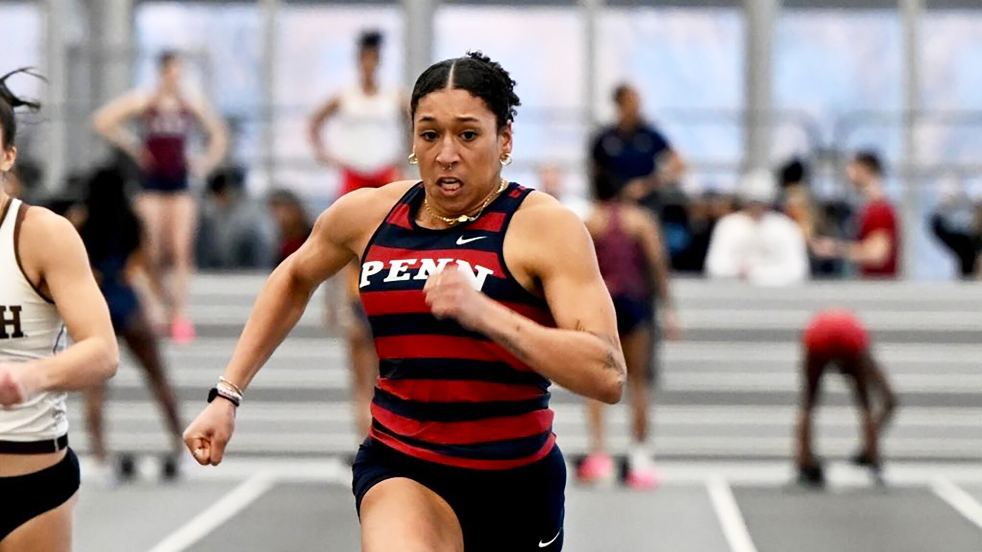  Isabella Whittaker races down the track during an indoor meet.