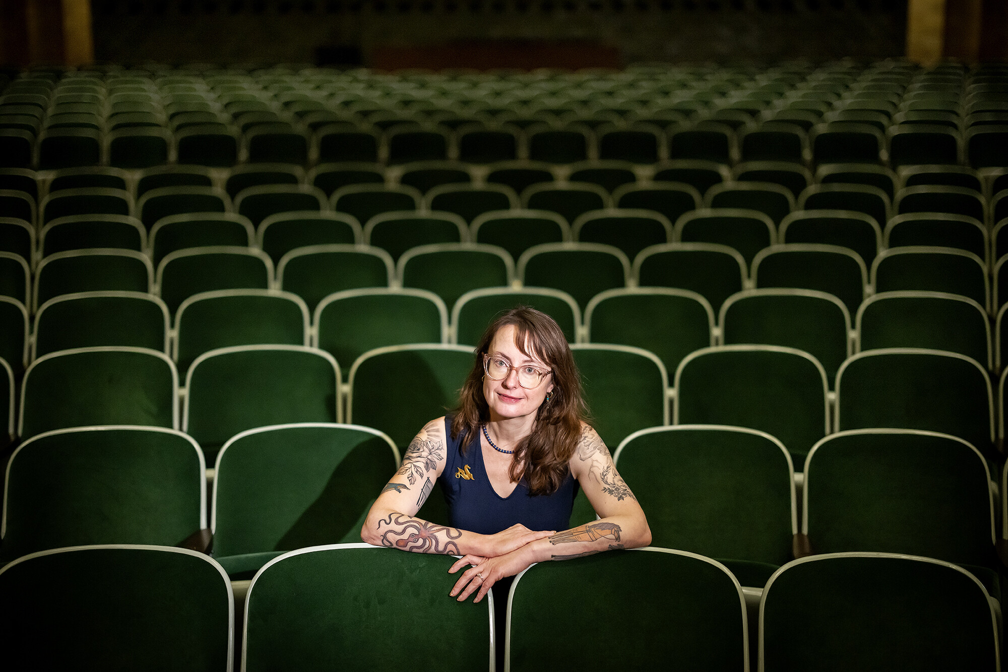 emily wilson sitting in the penn museum auditorium 