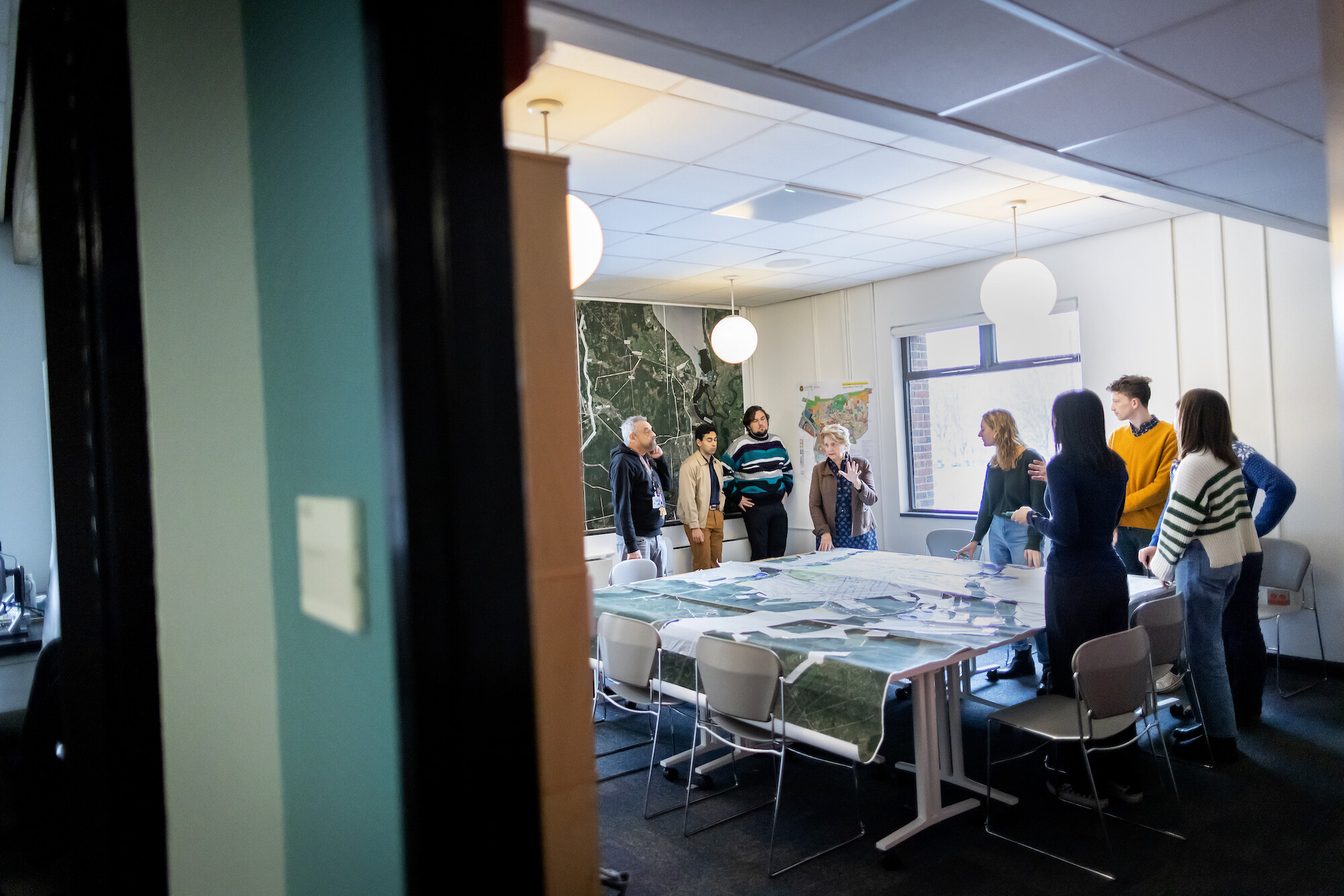 People stand around a table.