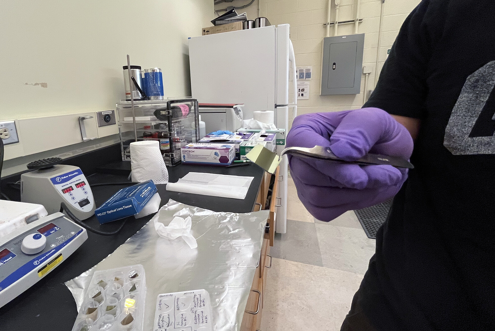 Researcher holds a thin glass film