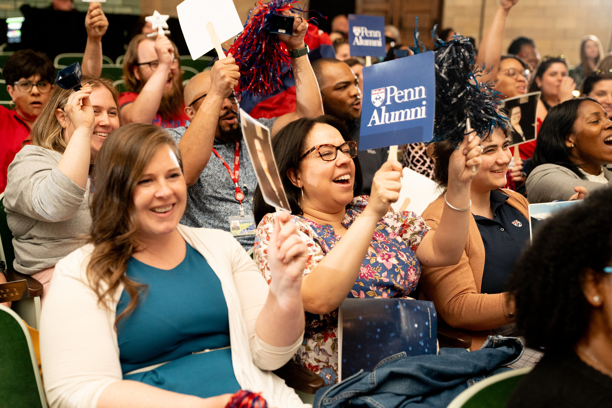 Staff support colleagues with signs at Models of Excellence Award Ceremony