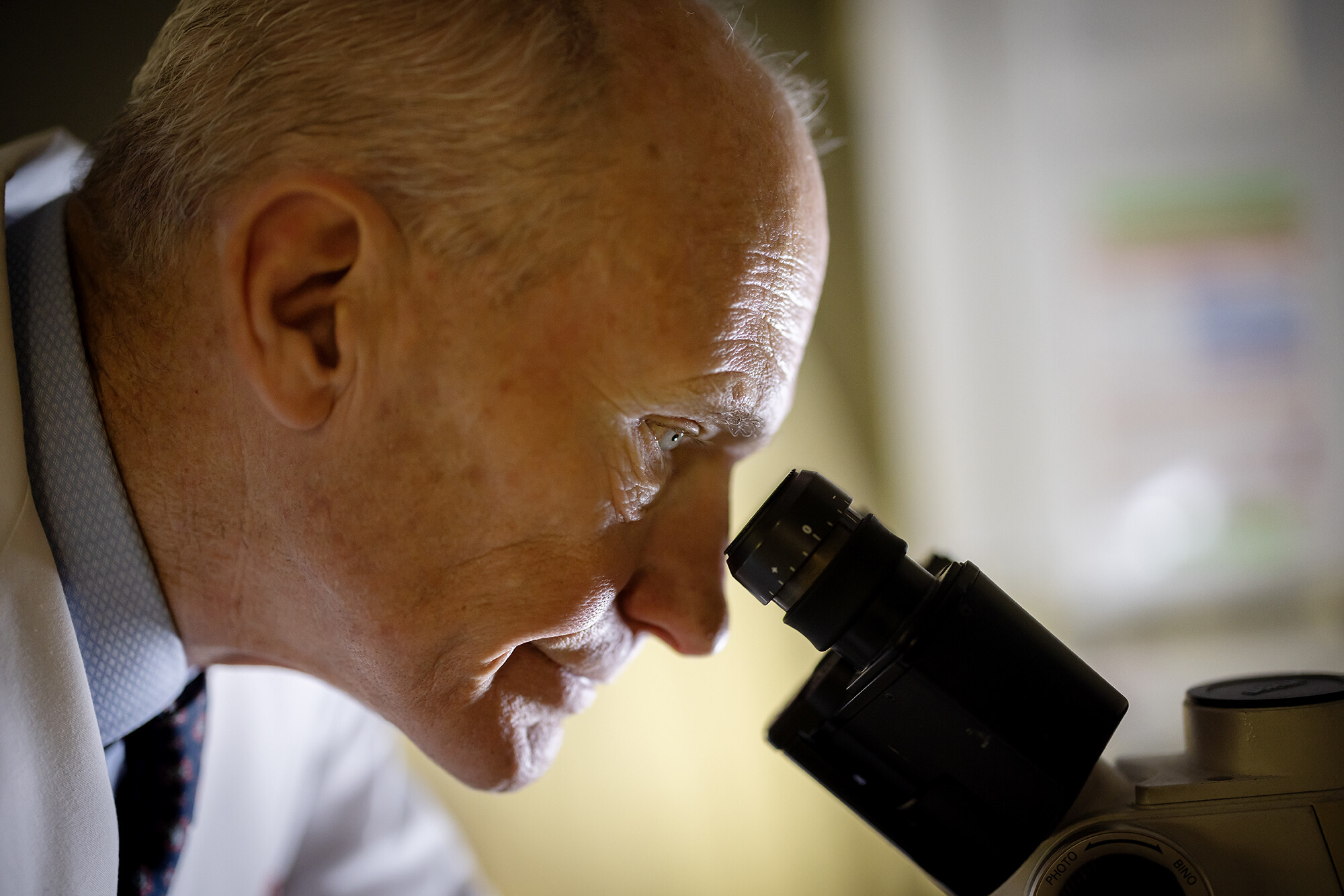 carl june looking through microscope