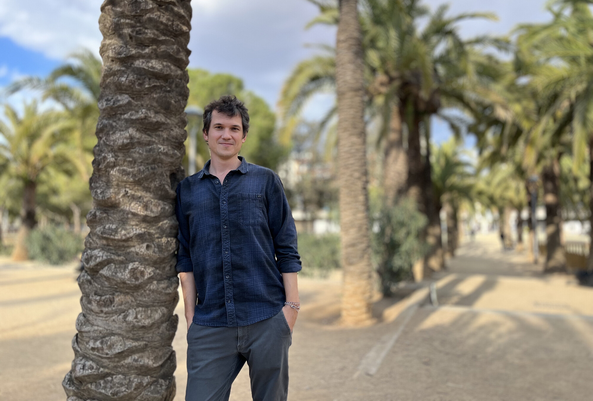 Marc Marin Webb poses next to tree.