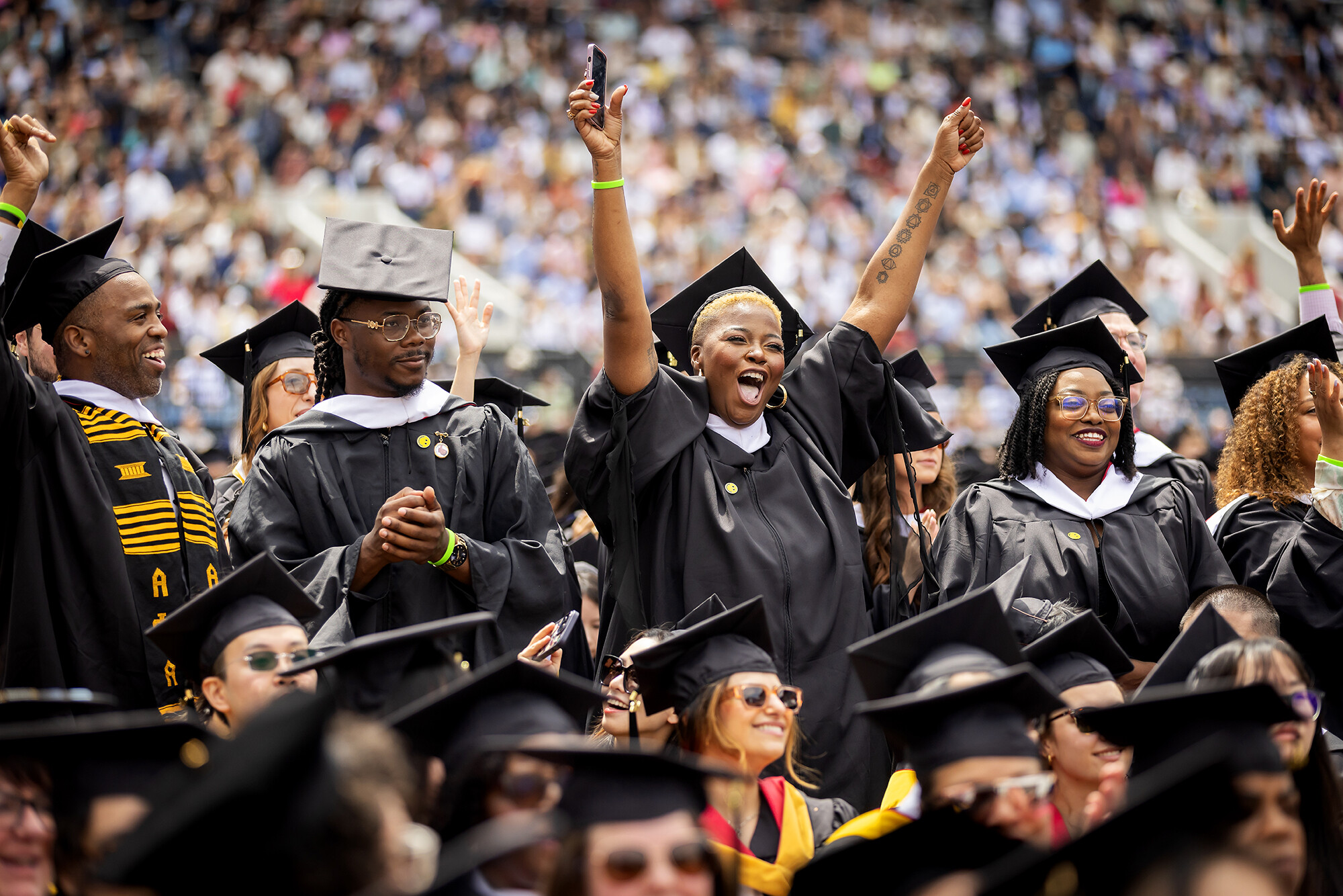 students cheering during commencement