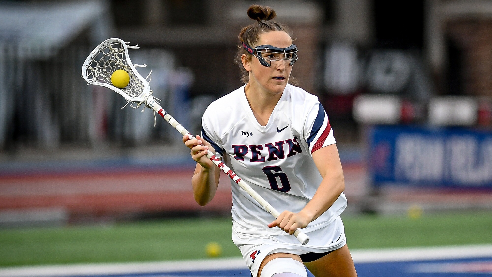 Izzy Rohr makes a move with the ball in her lacrosse stick.