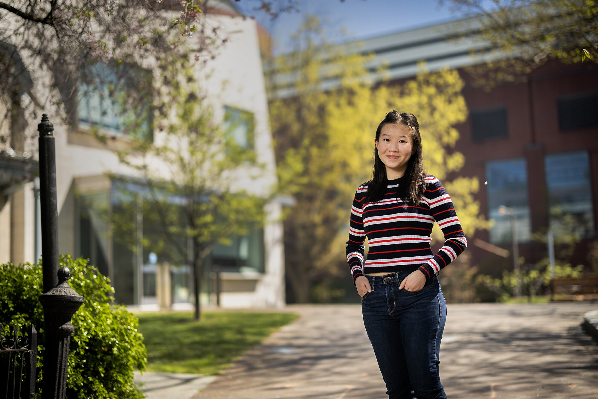 Jing-Jing Piriyalertsak standing outside a building with trees