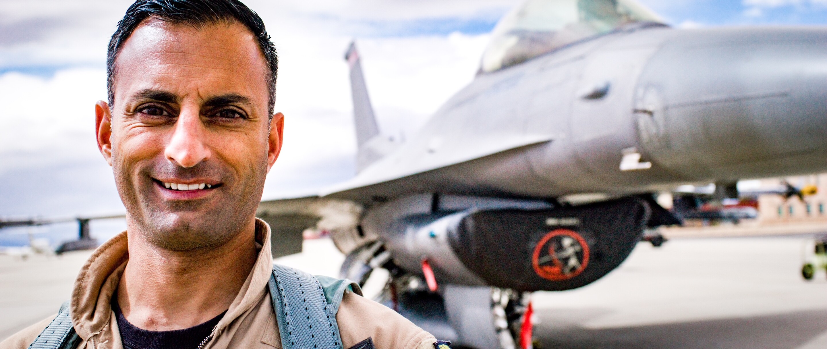 Wharton MBA student Jameel Janjua in front of an F-16. 