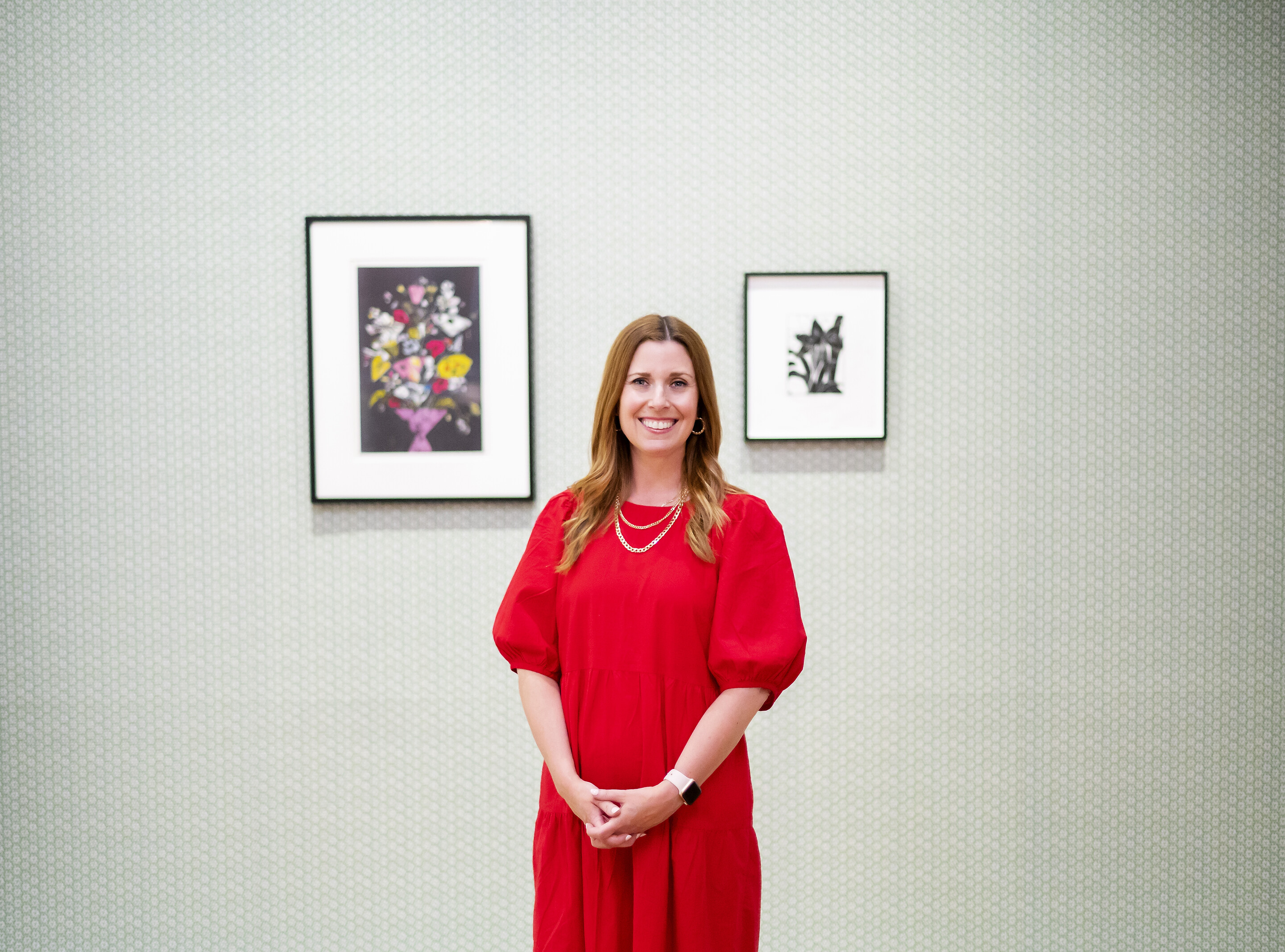 Lynn Dolby standing in front of two artworks