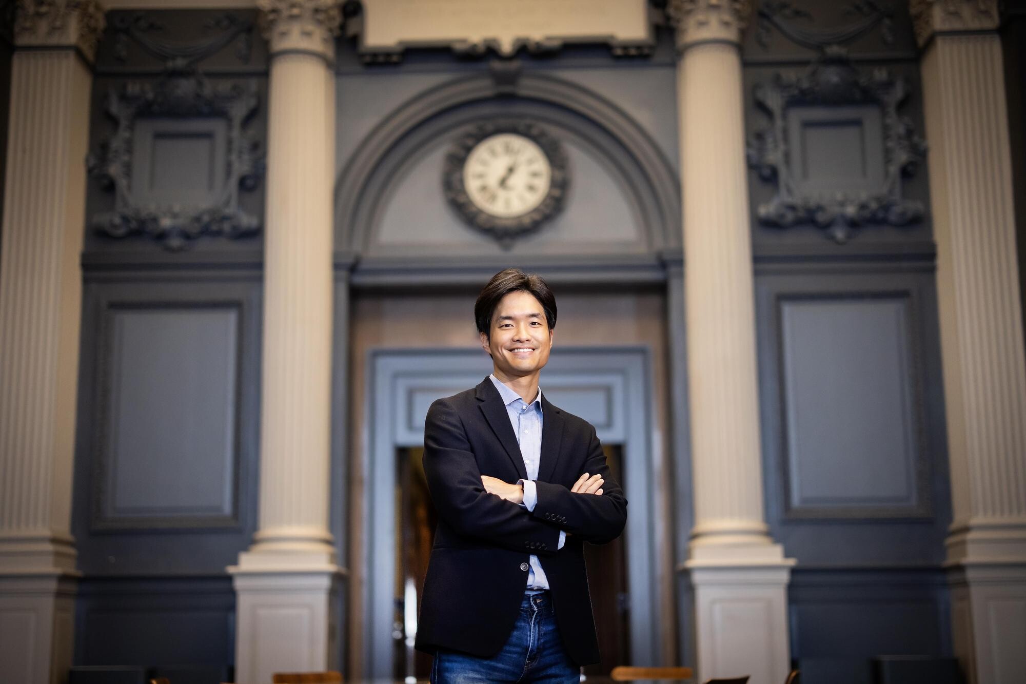 Jaehyung Ahn stands in a large room.