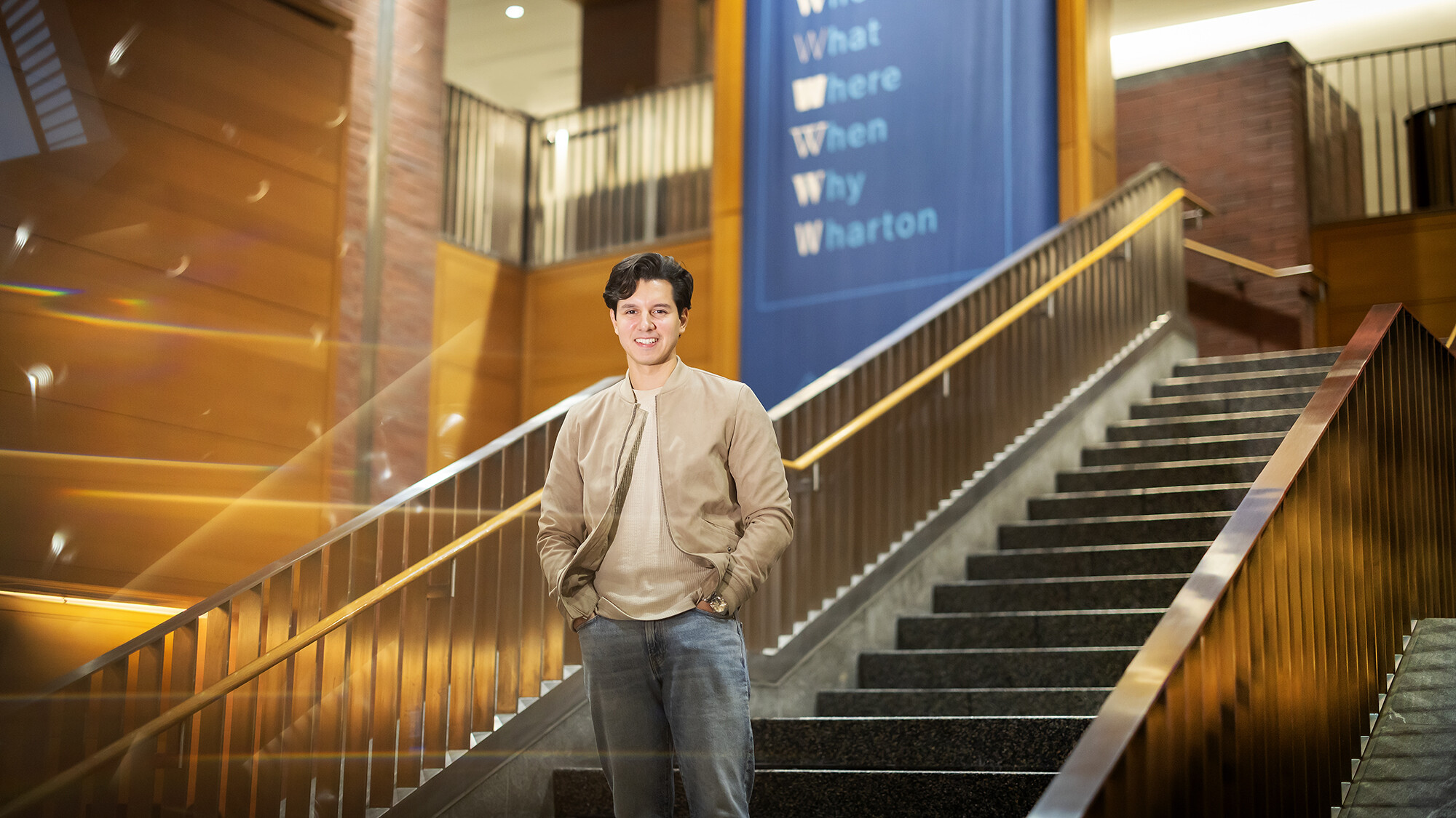 Derek Gibbs poses inside Wharton near the steps.