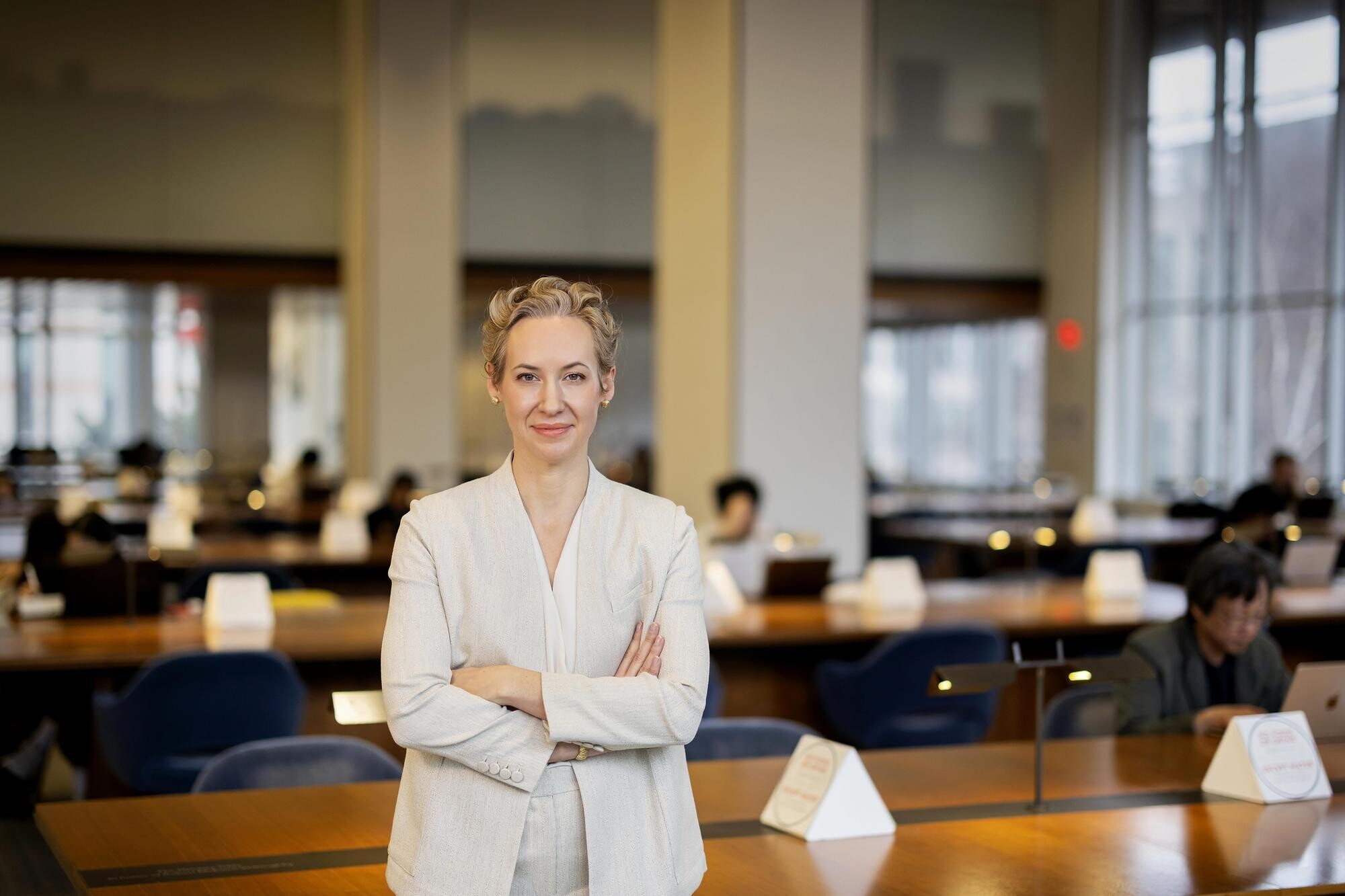 Brigitte Weinsteiger leaning against a table in a library reading room