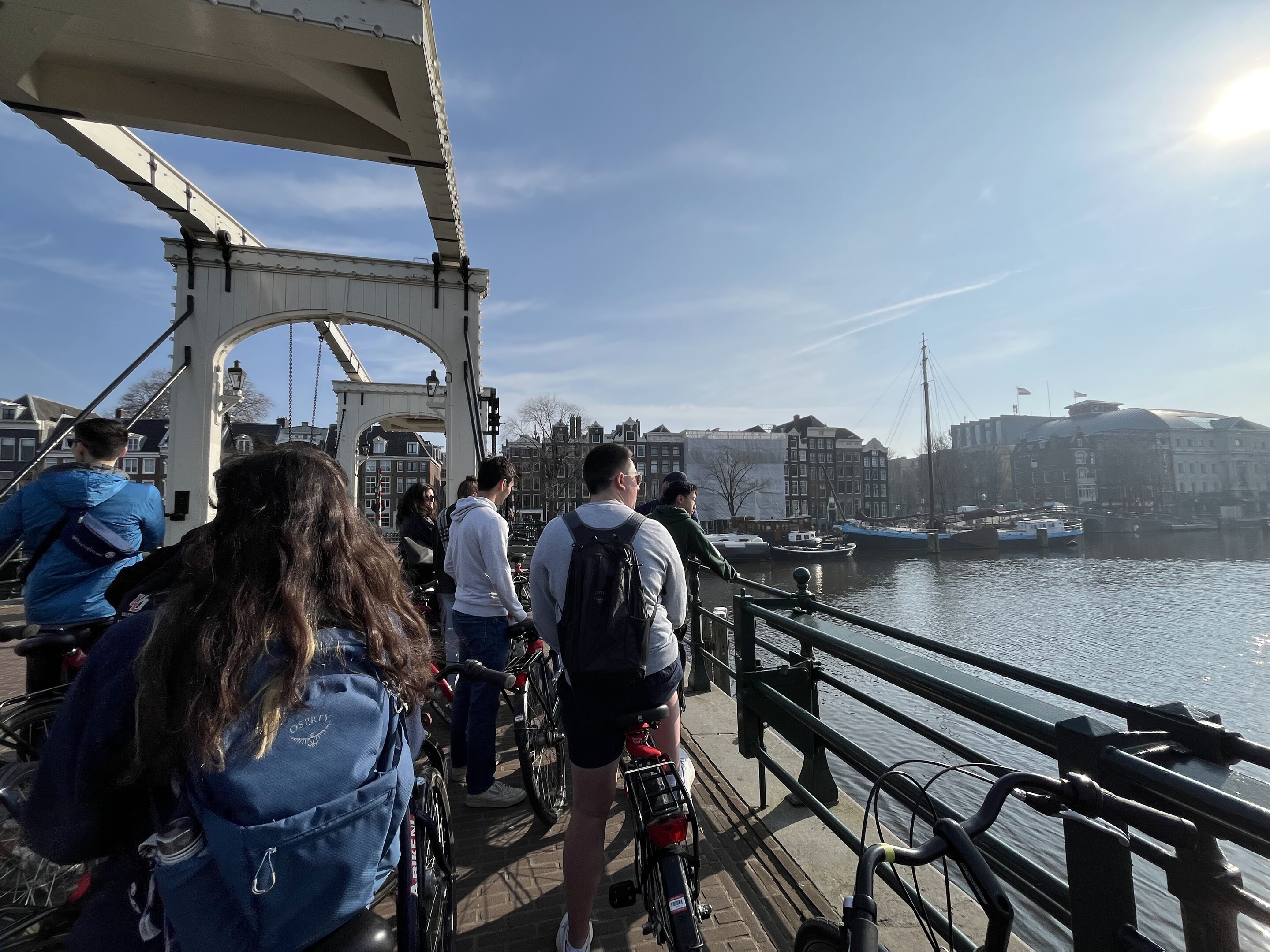 Penn students riding bikes over a bridge in Amsterdam.