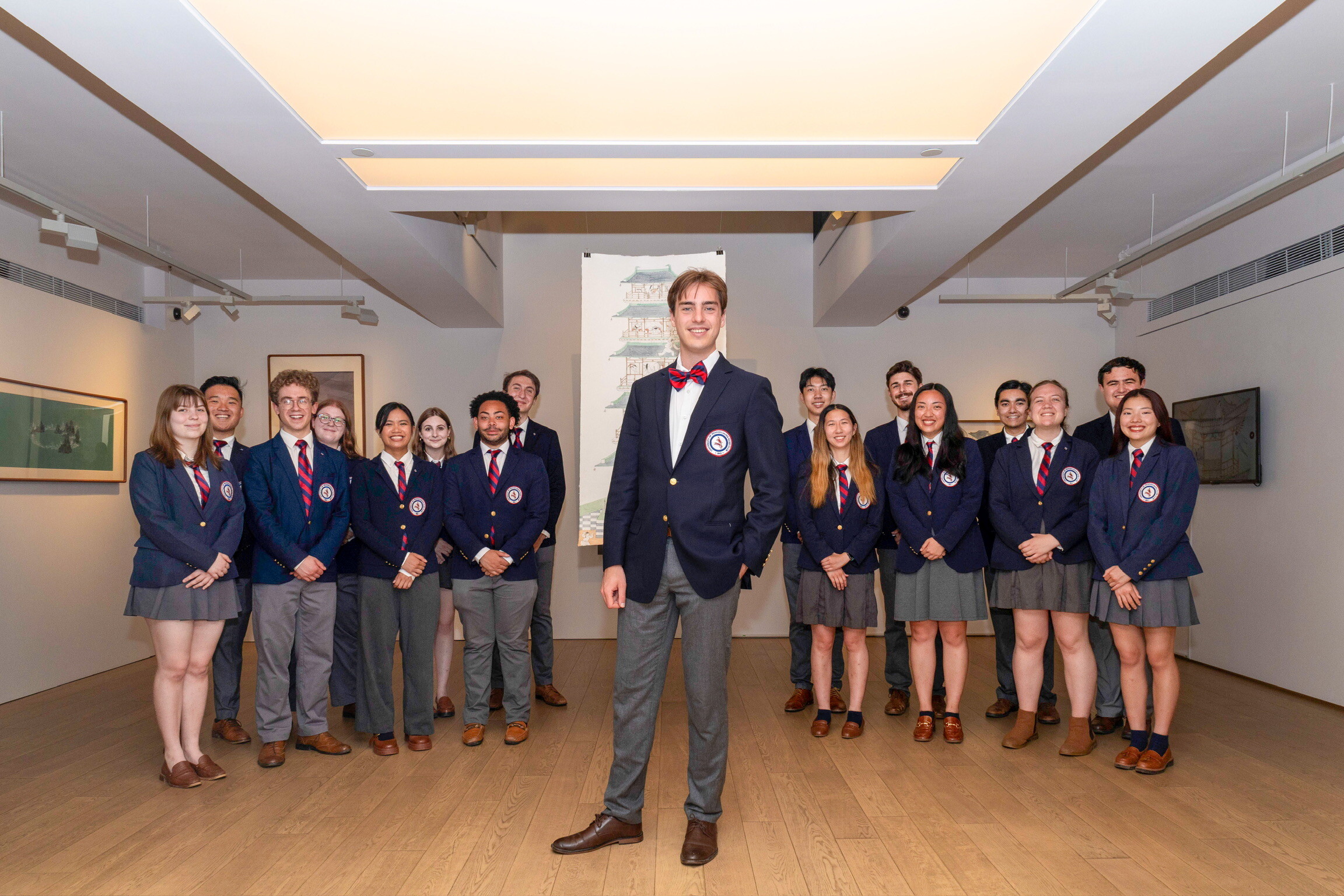 glee club members standing in art gallery