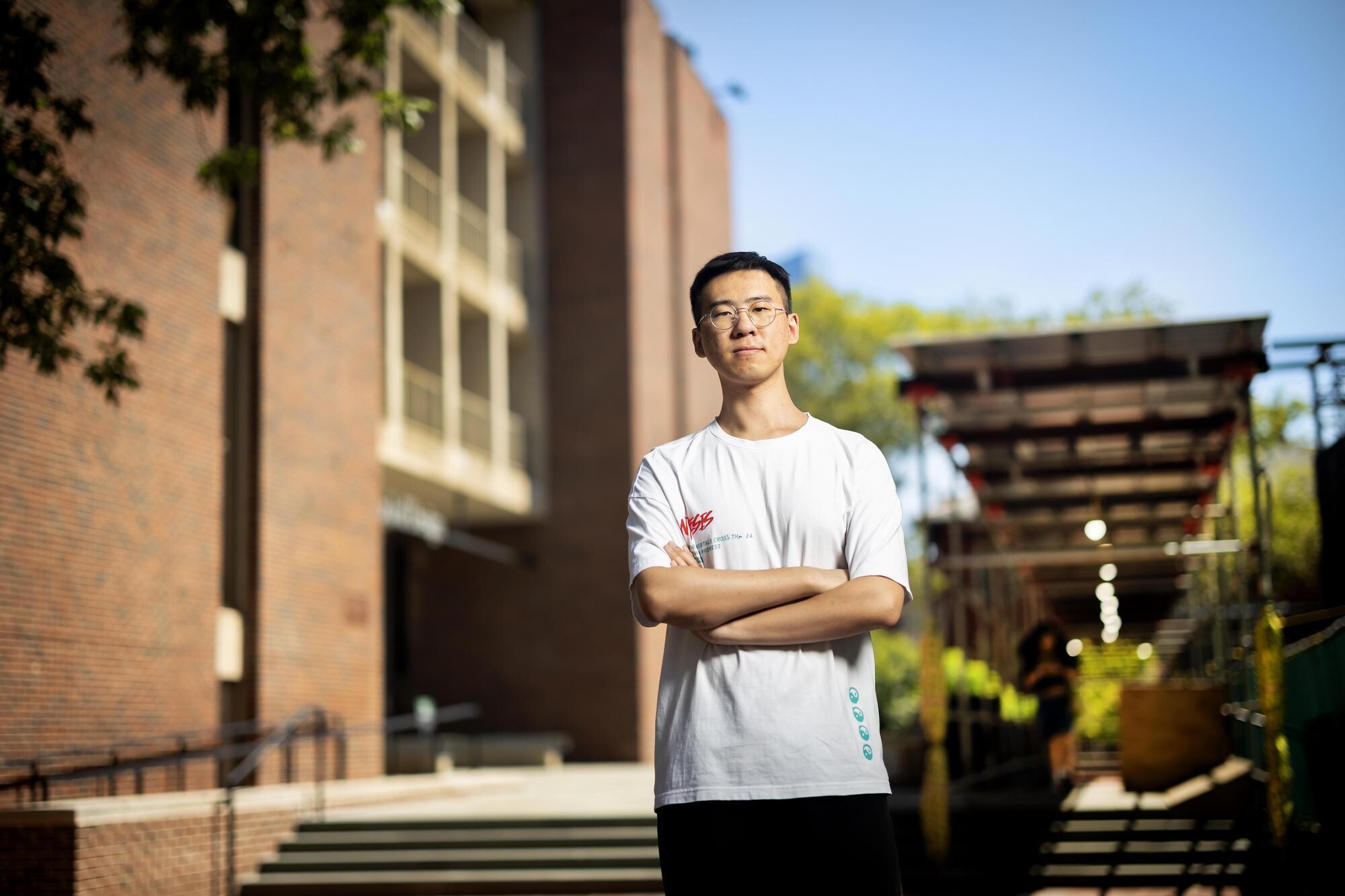 Frank Chen, a graduate student in the Weitzman School of Design, standing outdoors at Weitzman Plaza.