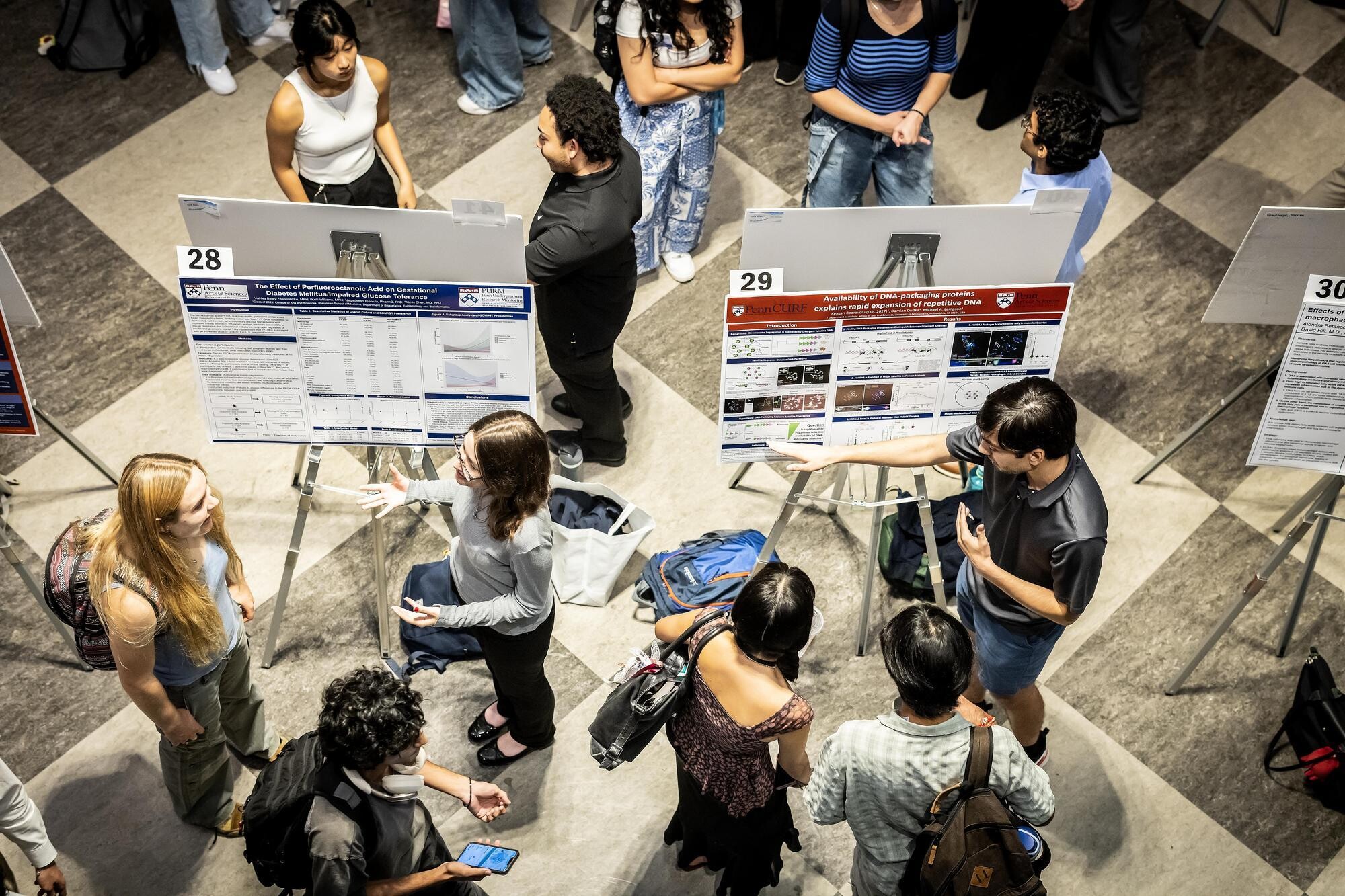 Students showing their posters at Houston Hall at CURF’s Poster Expo.