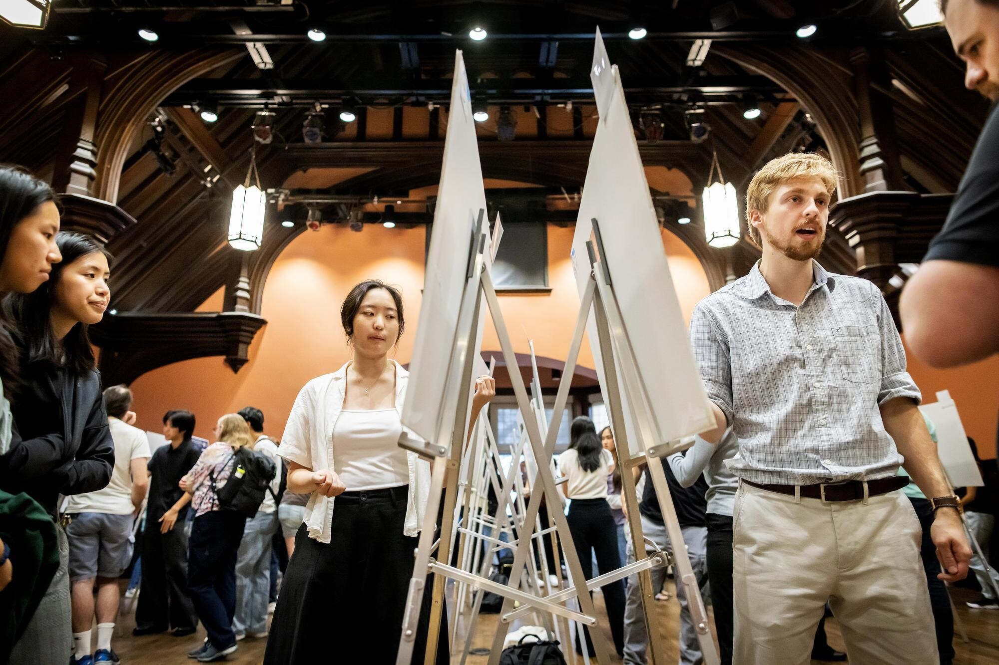 Students standing at their posters at the CURF Poster Expo in Houston Hall.