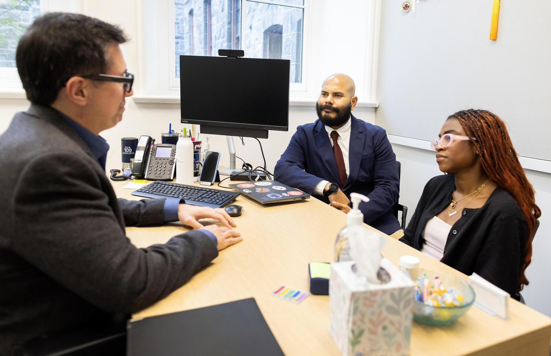 Marc Lo (left) and Enmanuel Martínez (center) speaking with Mayokun Omitogun (right)