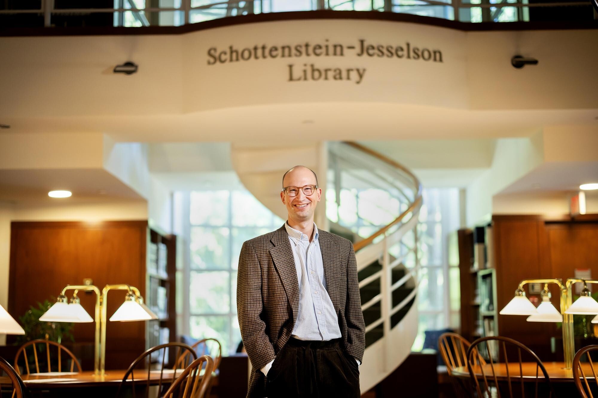 Mendel Kranz in the Schottenstein-Jesselson Library, standing upright and smiling facing forward